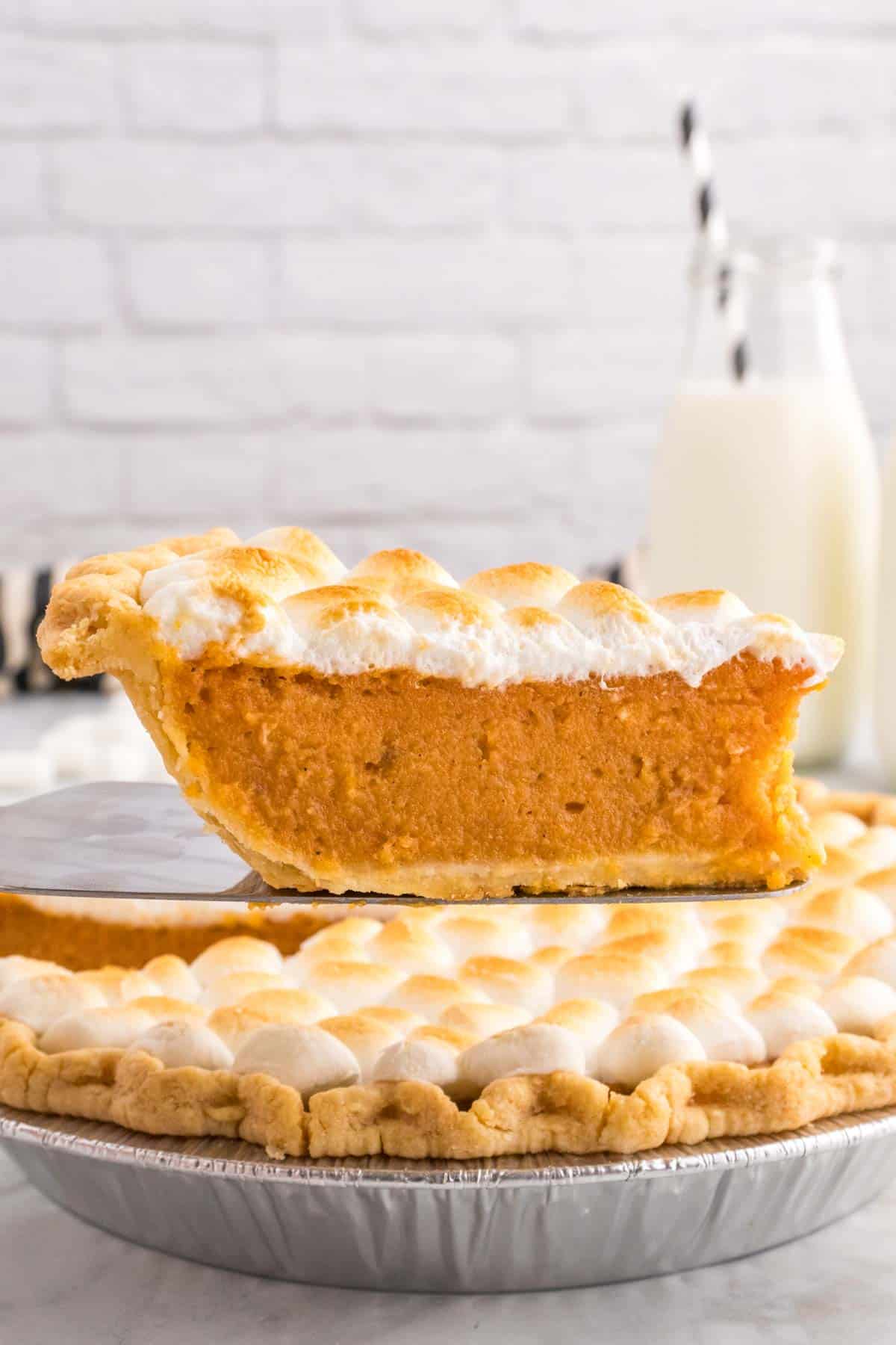 Sweet Potato Pie with Marshmallows is a classic Thanksgiving and Christmas dessert made with mashed sweet potatoes combined with butter, sugar, eggs, evaporated milk, cinnamon, nutmeg and ginger, baked in a flaky pie crust and topped with mini marshmallows.