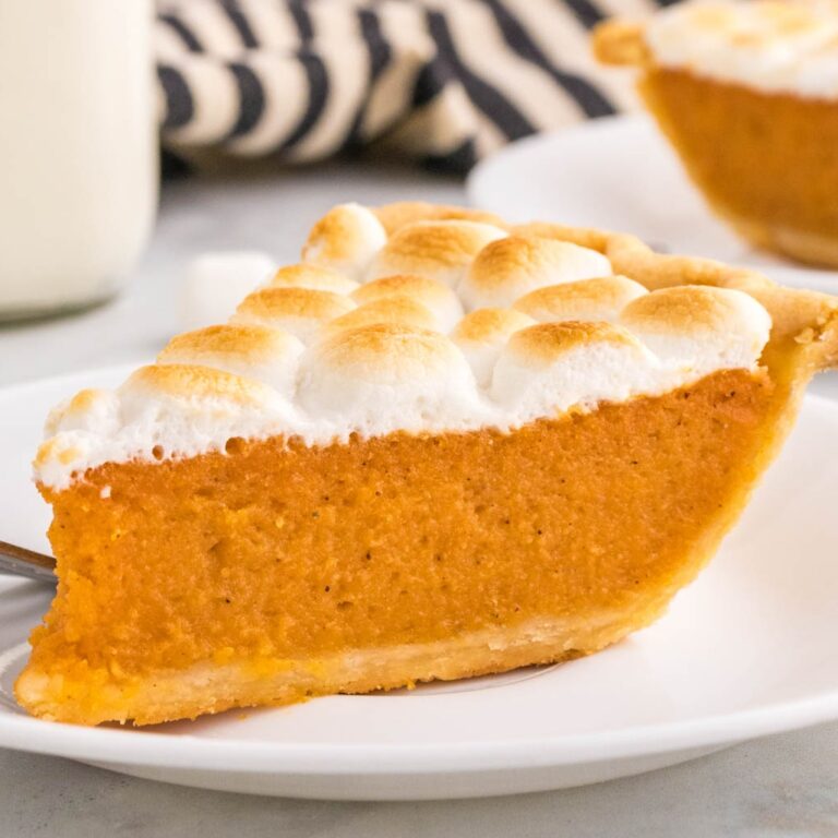 Sweet Potato Pie with Marshmallows is a classic Thanksgiving and Christmas dessert made with mashed sweet potatoes combined with butter, sugar, eggs, evaporated milk, cinnamon, nutmeg and ginger, baked in a flaky pie crust and topped with mini marshmallows.