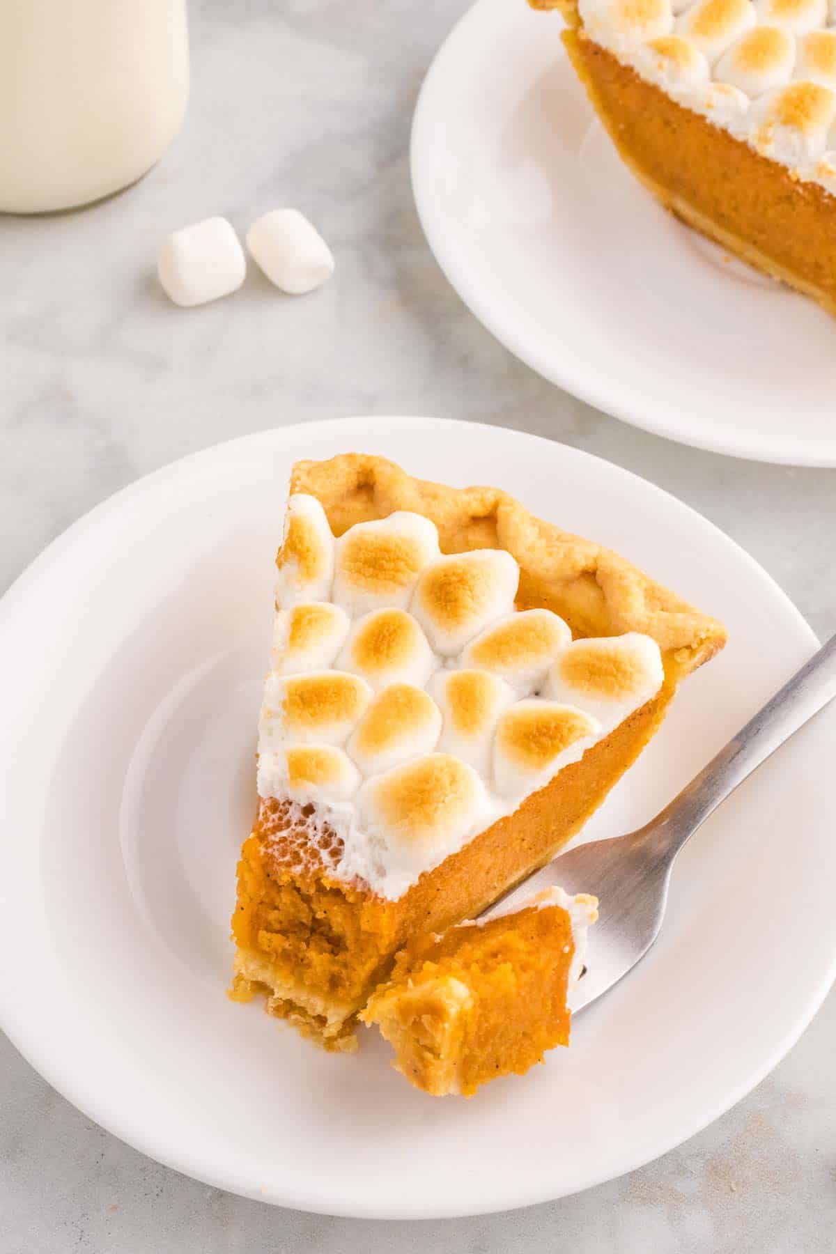 Sweet Potato Pie with Marshmallows is a classic Thanksgiving and Christmas dessert made with mashed sweet potatoes combined with butter, sugar, eggs, evaporated milk, cinnamon, nutmeg and ginger, baked in a flaky pie crust and topped with mini marshmallows.