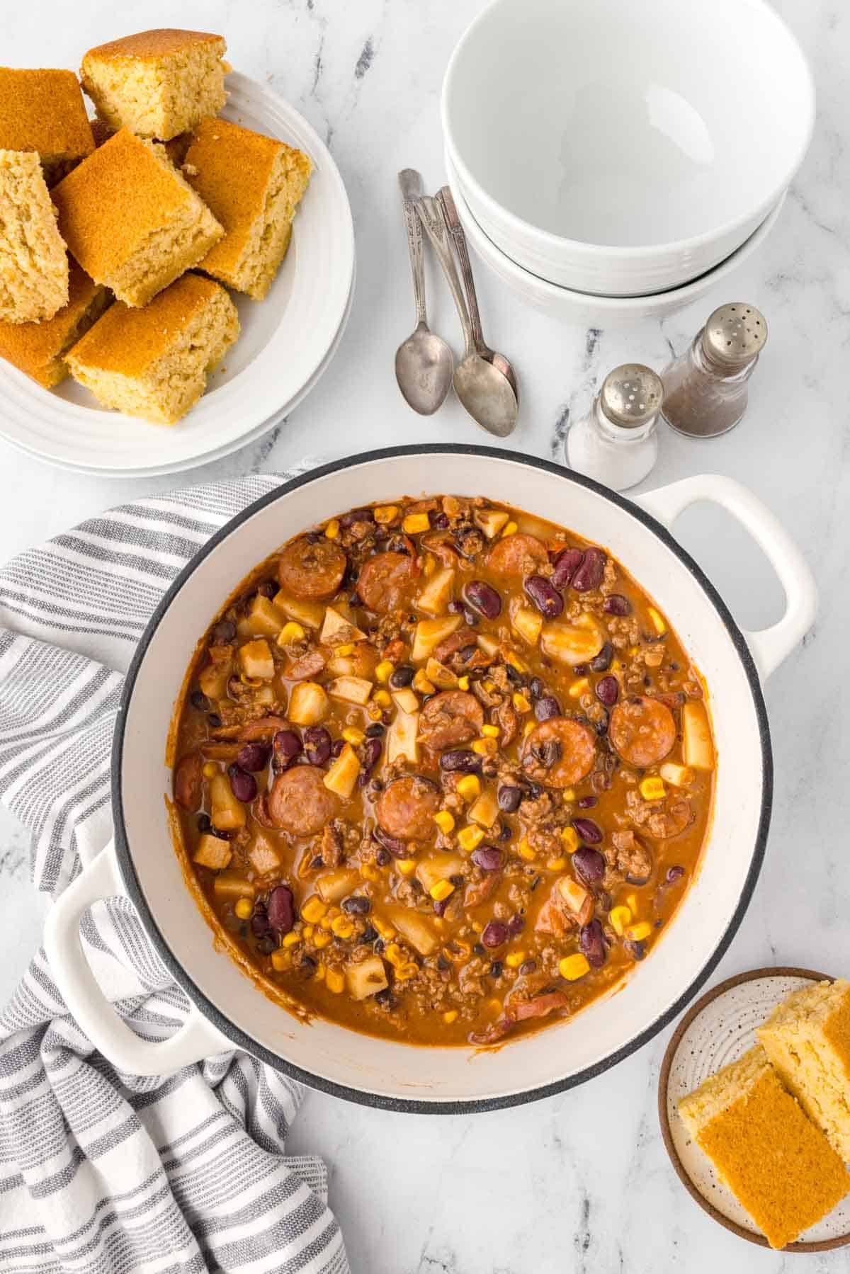 Texas Cowboy Stew is a hearty dish loaded with ground beef, smoked sausage, bacon, potatoes, corn, beans and diced tomatoes all in a flavourful beef broth.