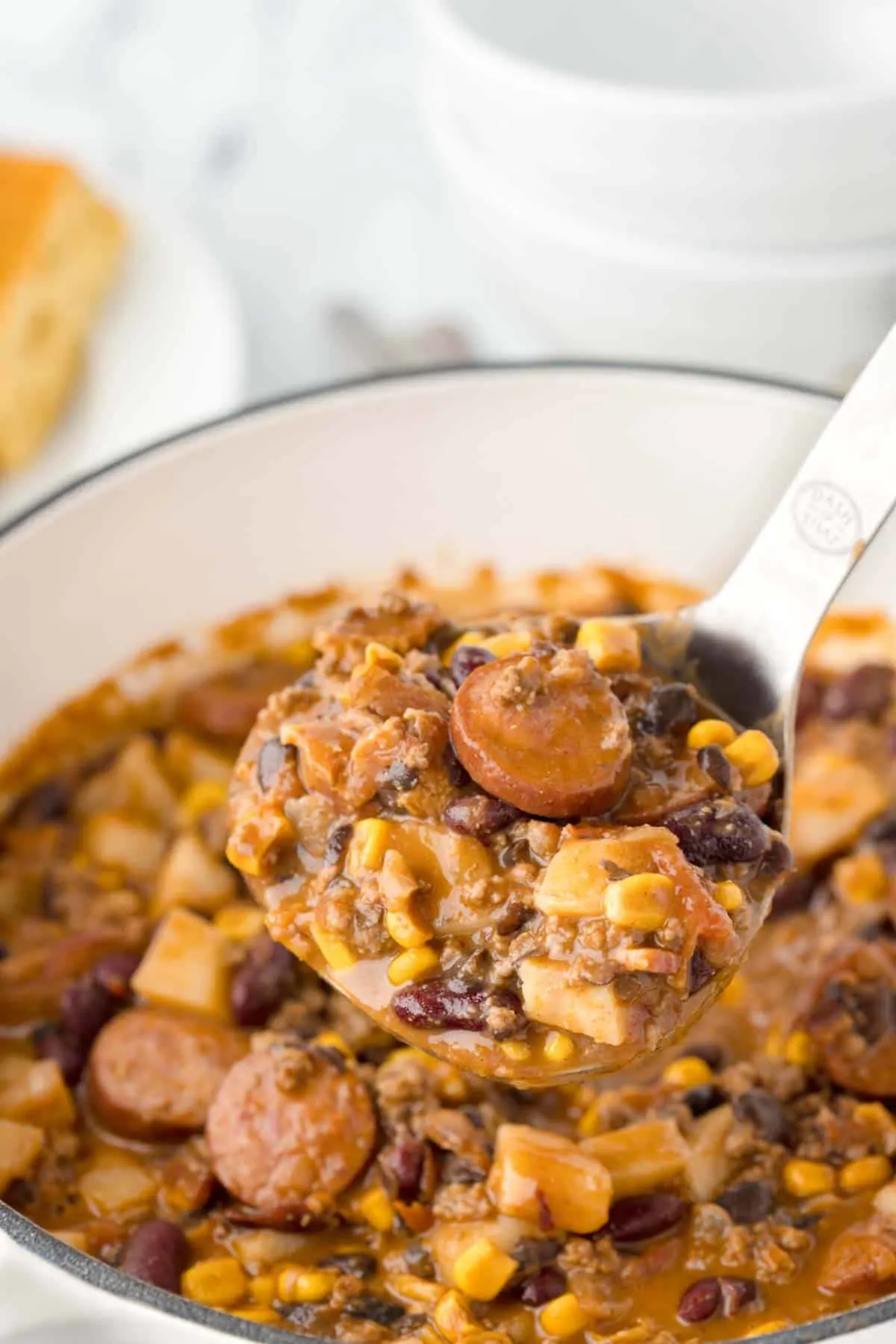 Texas Cowboy Stew is a hearty dish loaded with ground beef, smoked sausage, bacon, potatoes, corn, beans and diced tomatoes all in a flavourful beef broth.