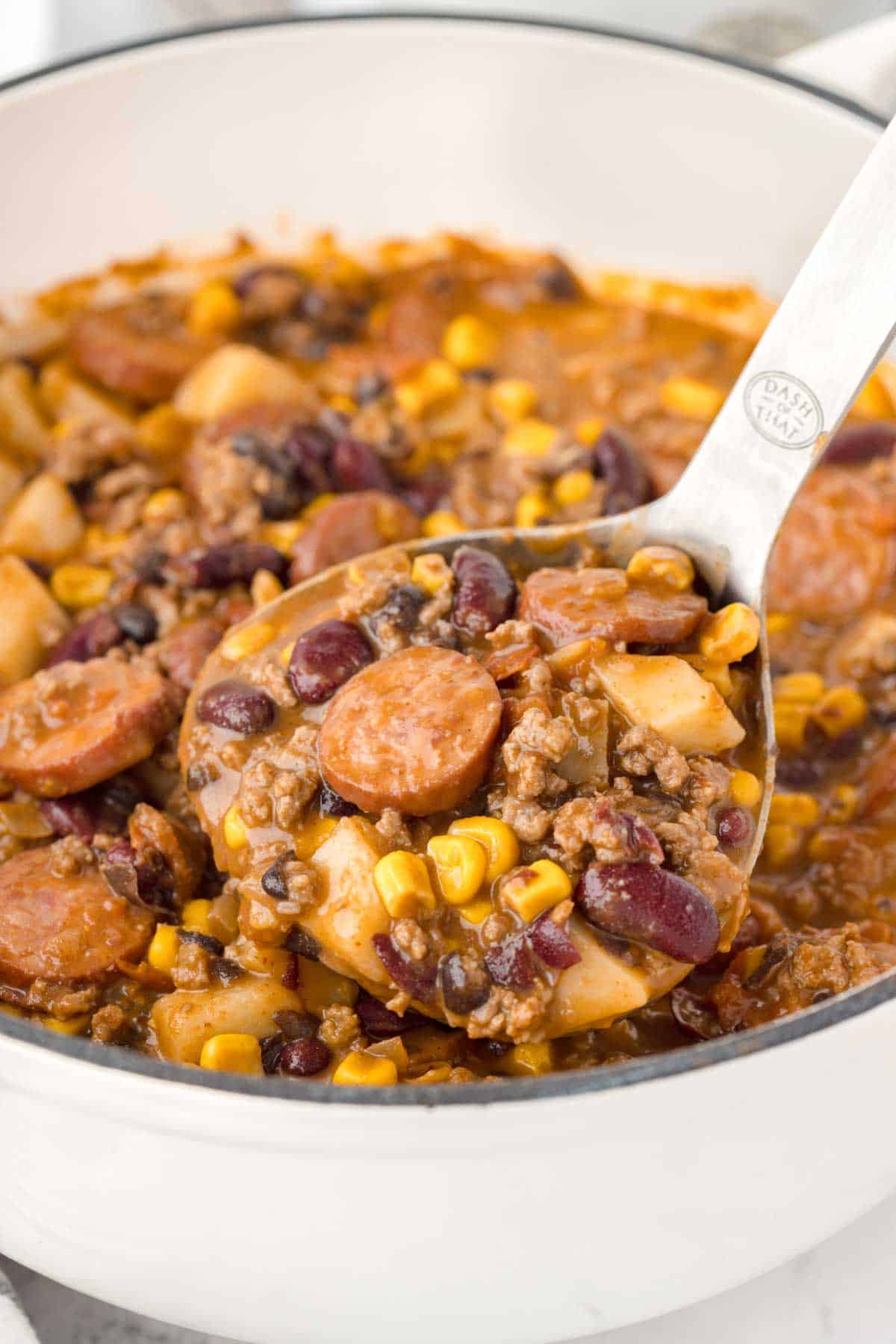 Texas Cowboy Stew is a hearty dish loaded with ground beef, smoked sausage, bacon, potatoes, corn, beans and diced tomatoes all in a flavourful beef broth.