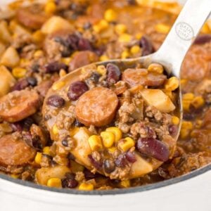 Texas Cowboy Stew is a hearty dish loaded with ground beef, smoked sausage, bacon, potatoes, corn, beans and diced tomatoes all in a flavourful beef broth.