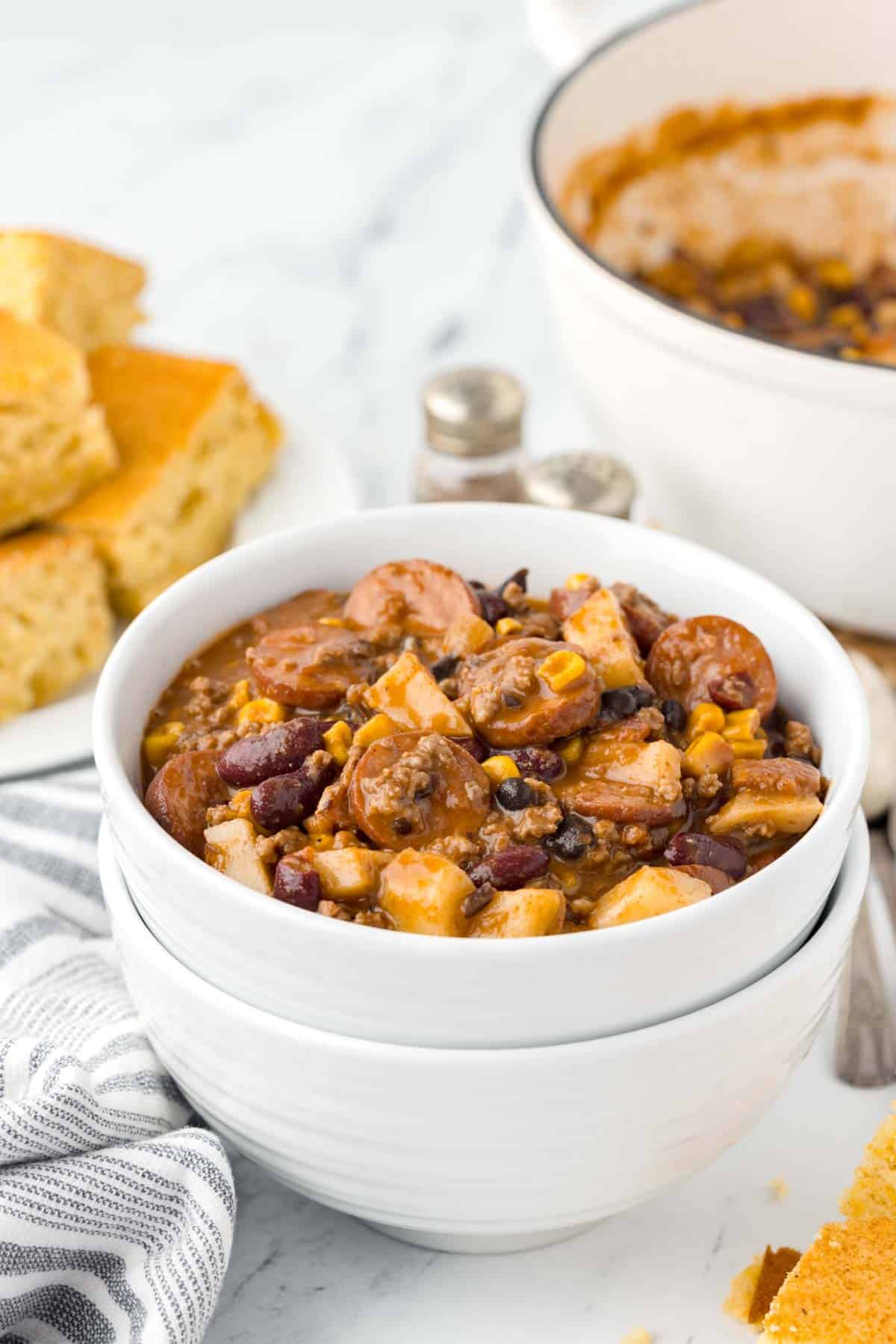 Texas Cowboy Stew is a hearty dish loaded with ground beef, smoked sausage, bacon, potatoes, corn, beans and diced tomatoes all in a flavourful beef broth.