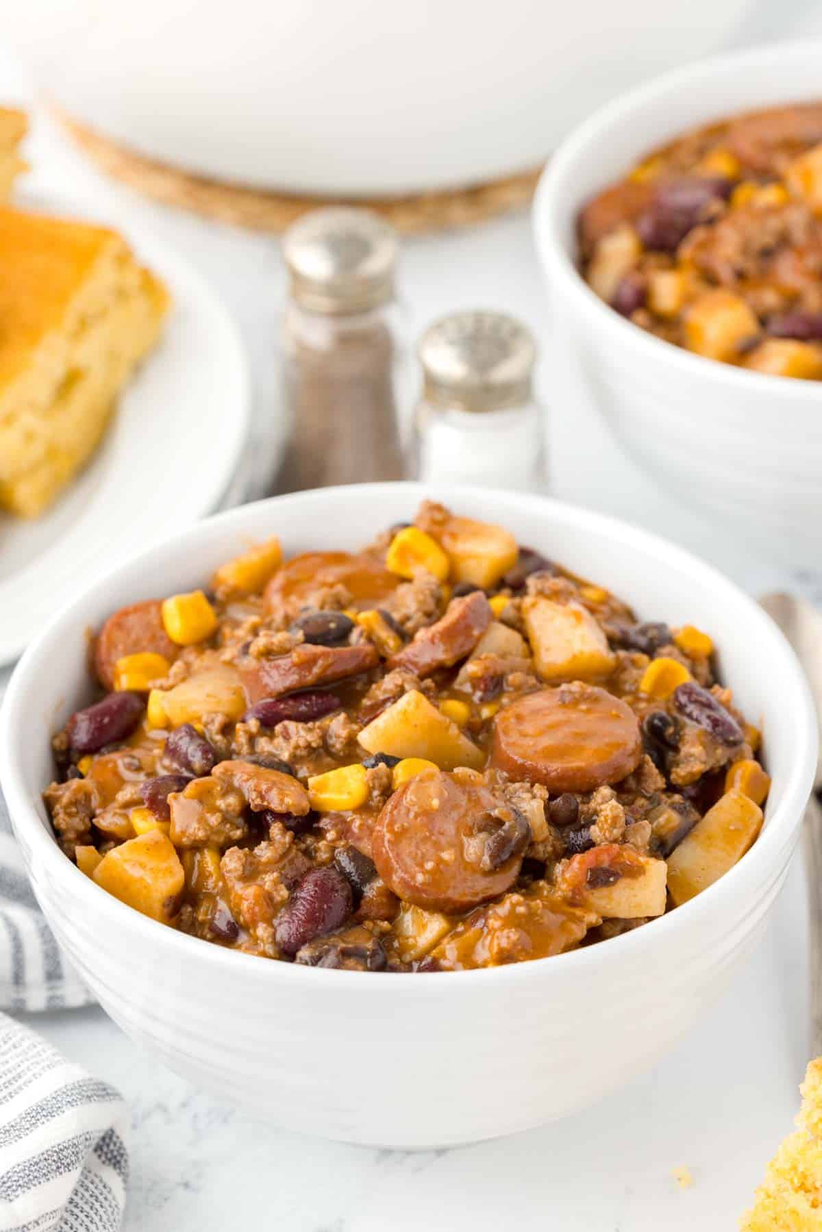 Texas Cowboy Stew is a hearty dish loaded with ground beef, smoked sausage, bacon, potatoes, corn, beans and diced tomatoes all in a flavourful beef broth.