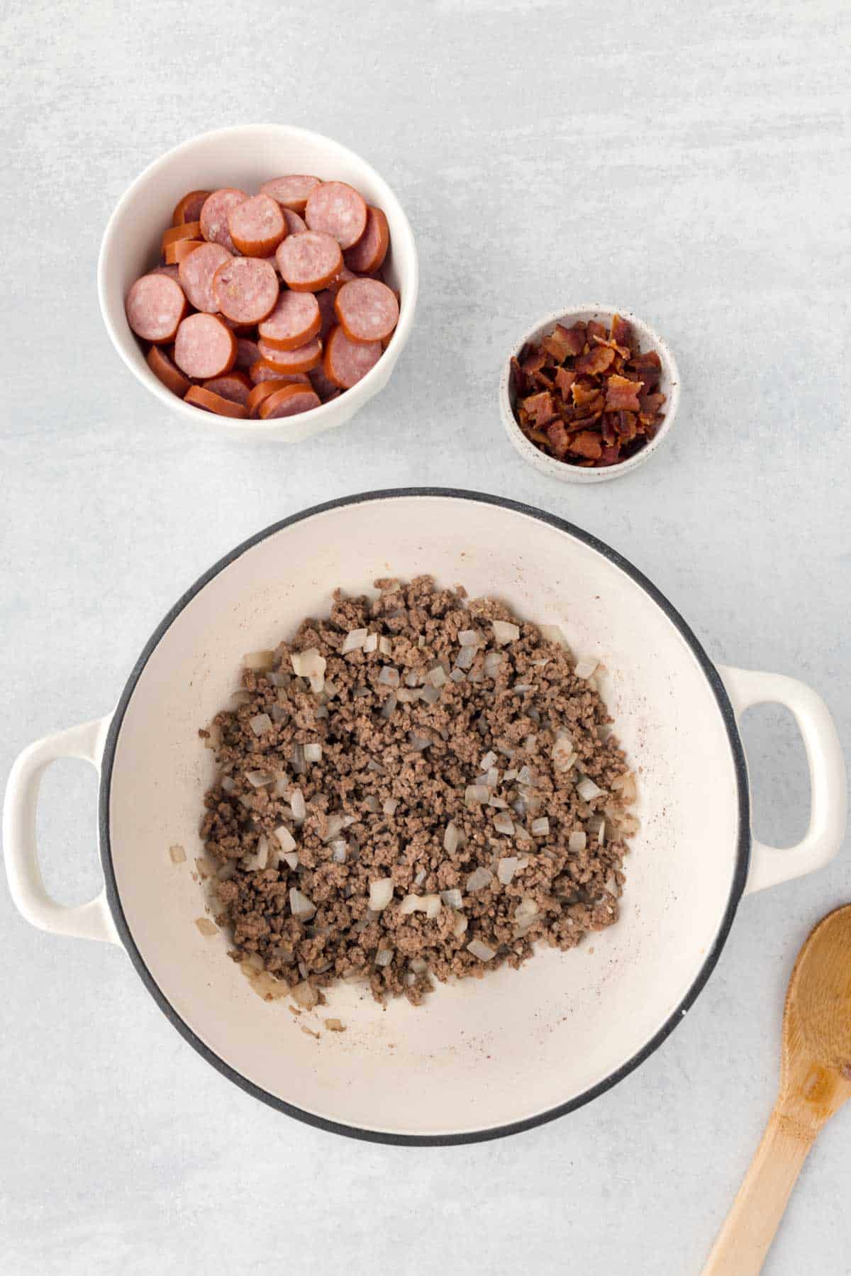 cooked ground beef and diced onions in a Dutch oven