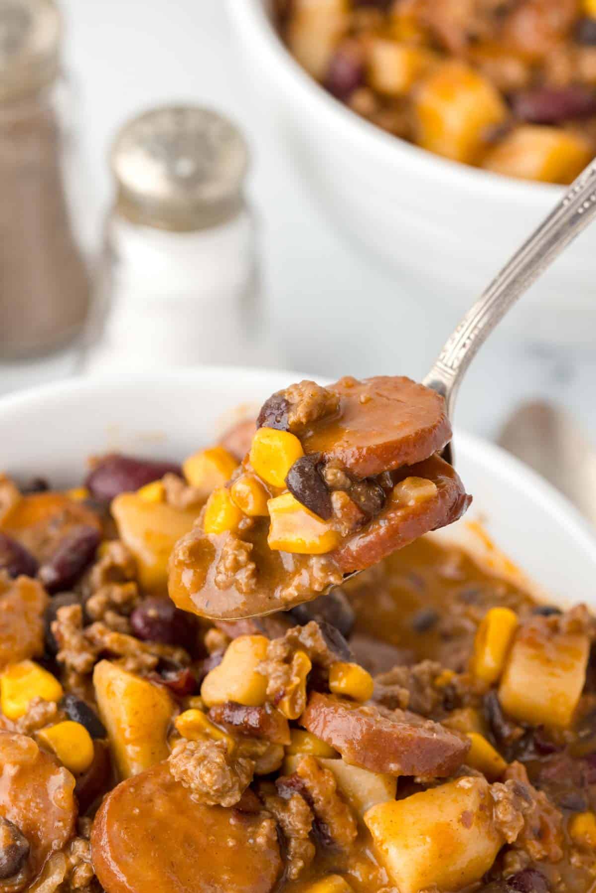 Texas Cowboy Stew is a hearty dish loaded with ground beef, smoked sausage, bacon, potatoes, corn, beans and diced tomatoes all in a flavourful beef broth.