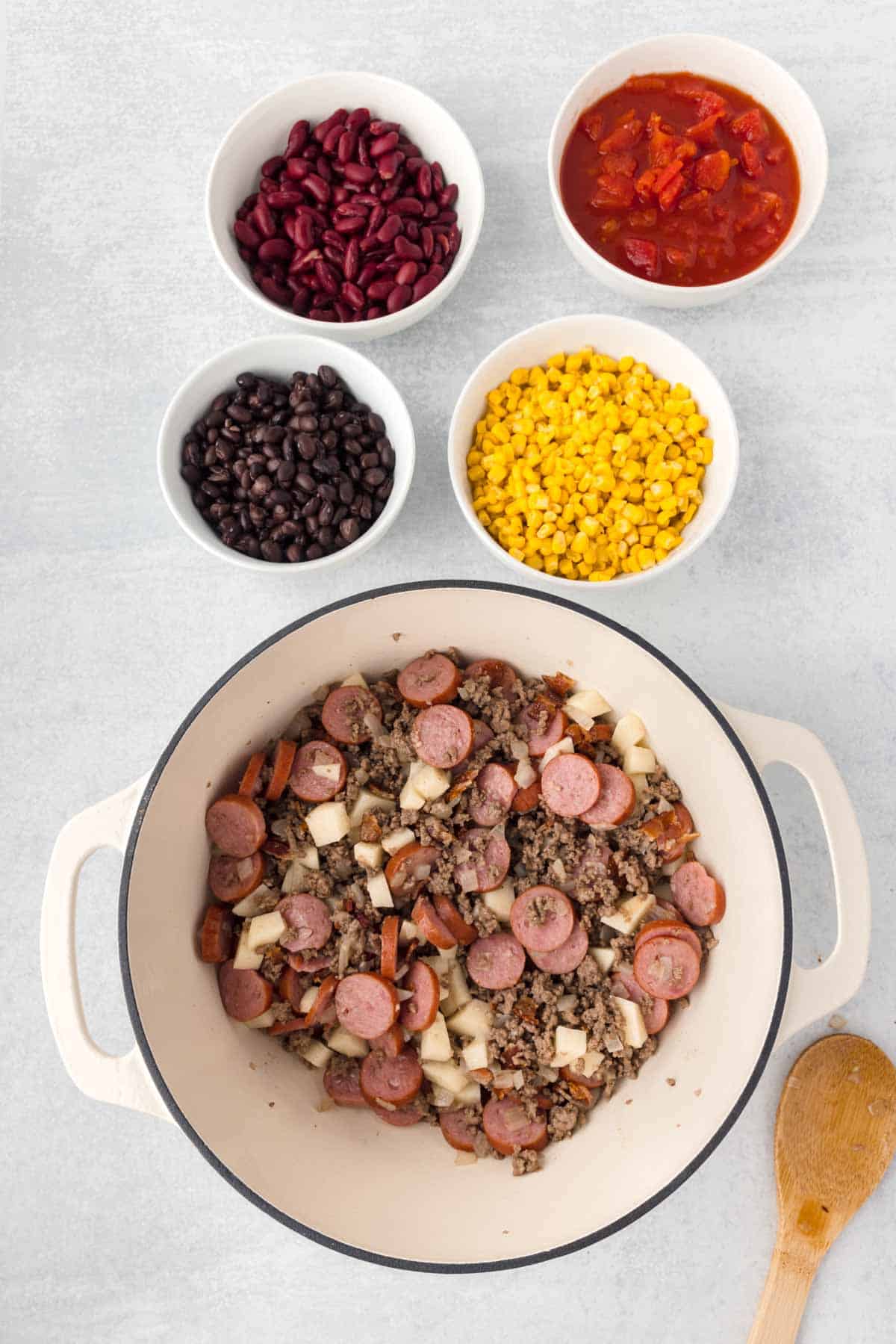 diced potatoes, sausage slices and cooked ground beef in a Dutch oven