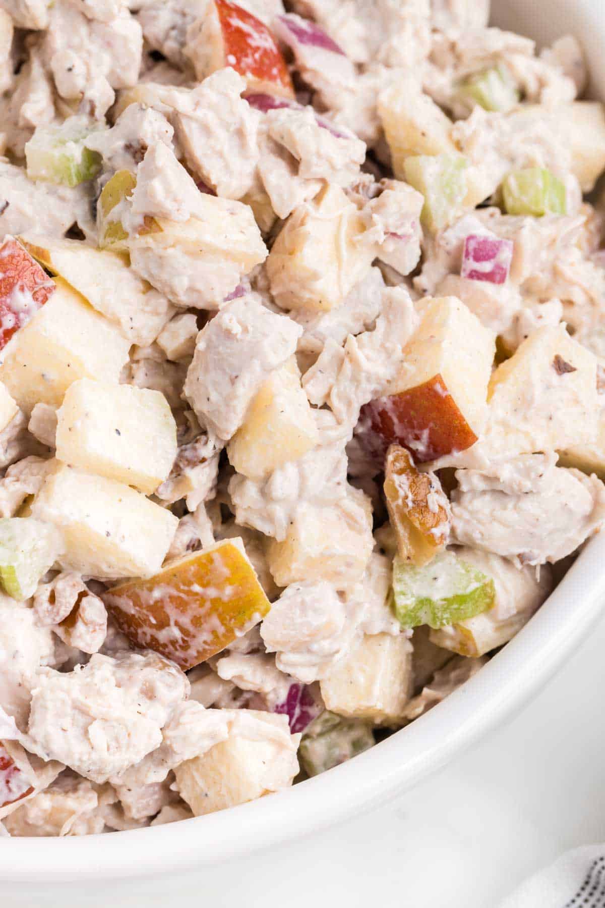 Apple Walnut Chicken Salad is a tasty lunch or dinner recipe using diced chicken, apples, chopped walnuts, celery and red onions all coated in a creamy mayo and sour cream based dressing.