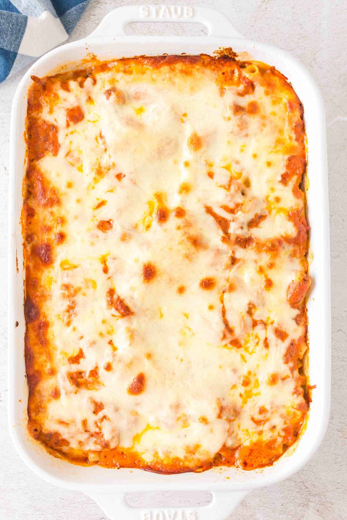 Baked Ziti with Ground Beef is a hearty baked pasta recipe loaded with ground beef, marinara sauce, sour cream, heavy cream, provolone and mozzarella cheese.