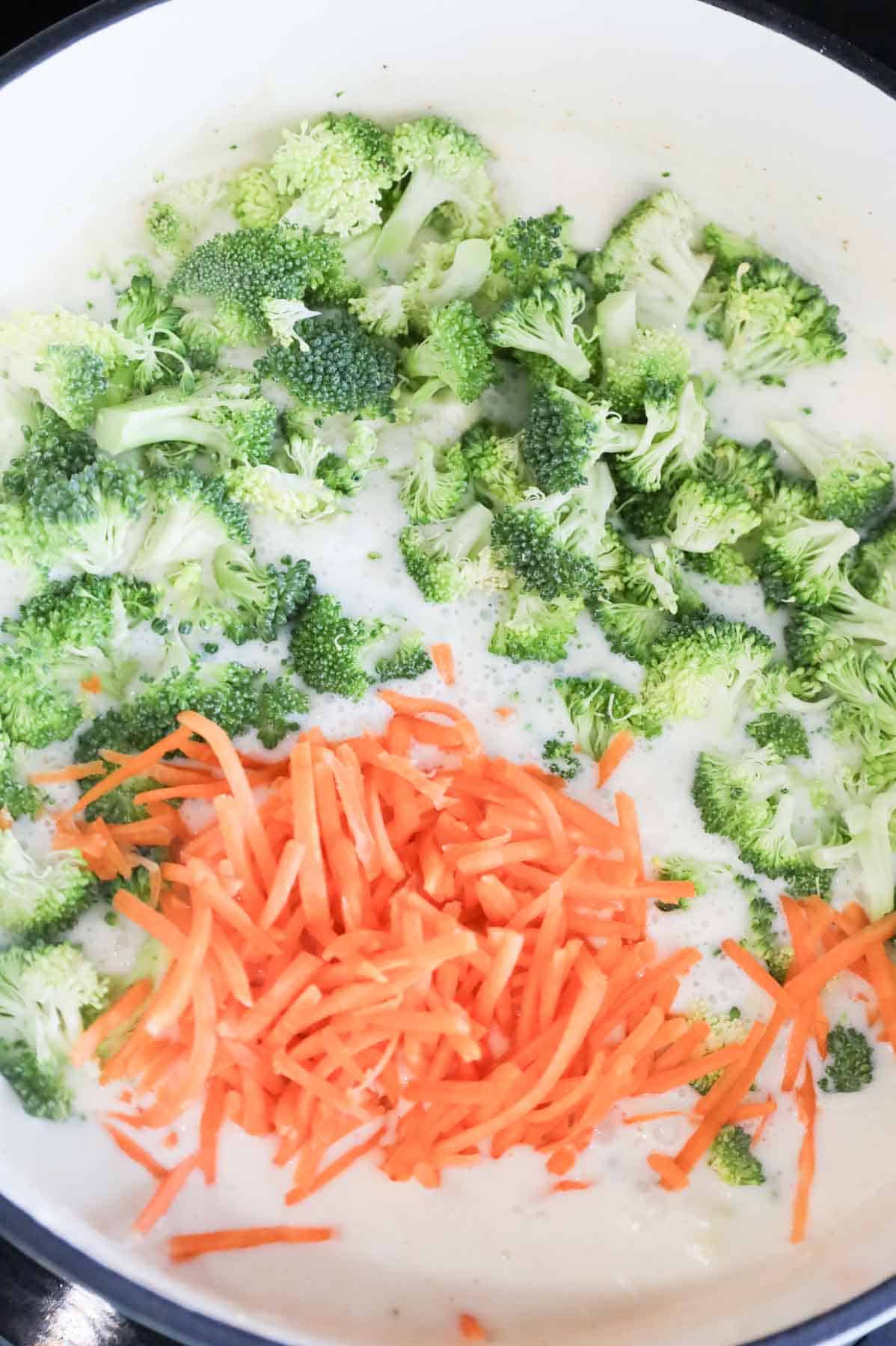 broccoli florets and shredded carrots added to pot with creamy broth mixture
