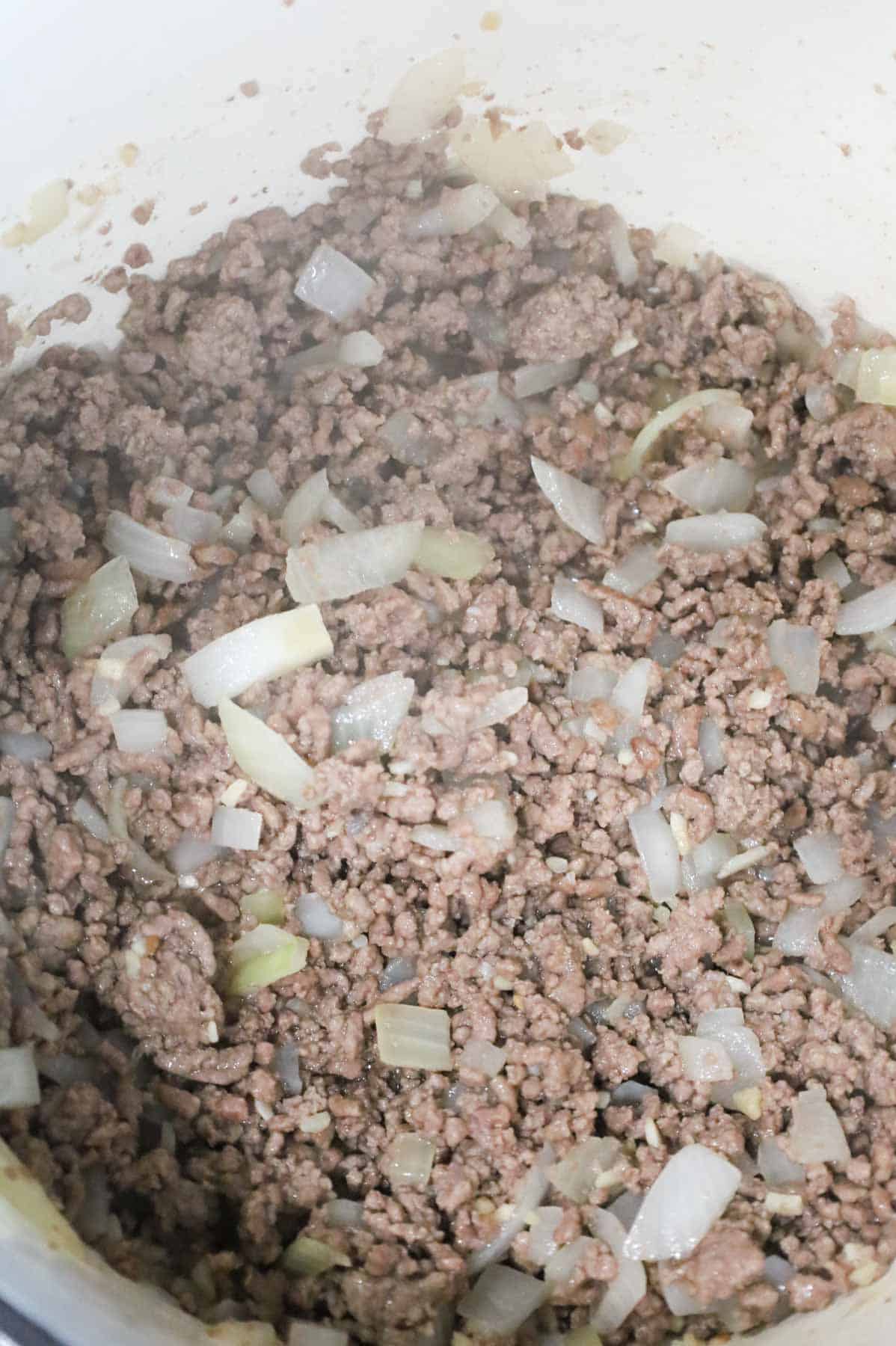 cooked ground beef, diced onions and minced garlic in a pot