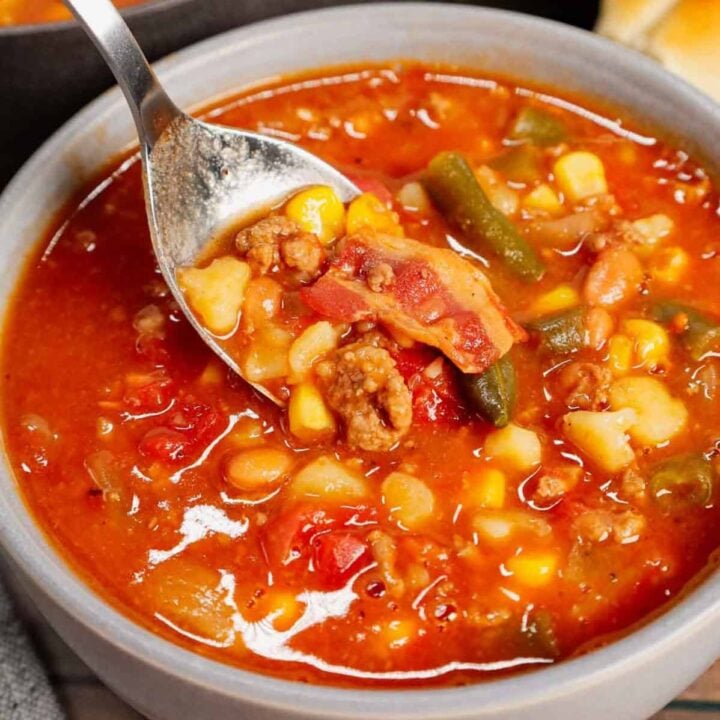 Cowboy Soup is hearty dish loaded with ground beef, bacon, Rotel, Bush's Original baked beans, green beans, corn and diced potatoes all in a flavourful broth.