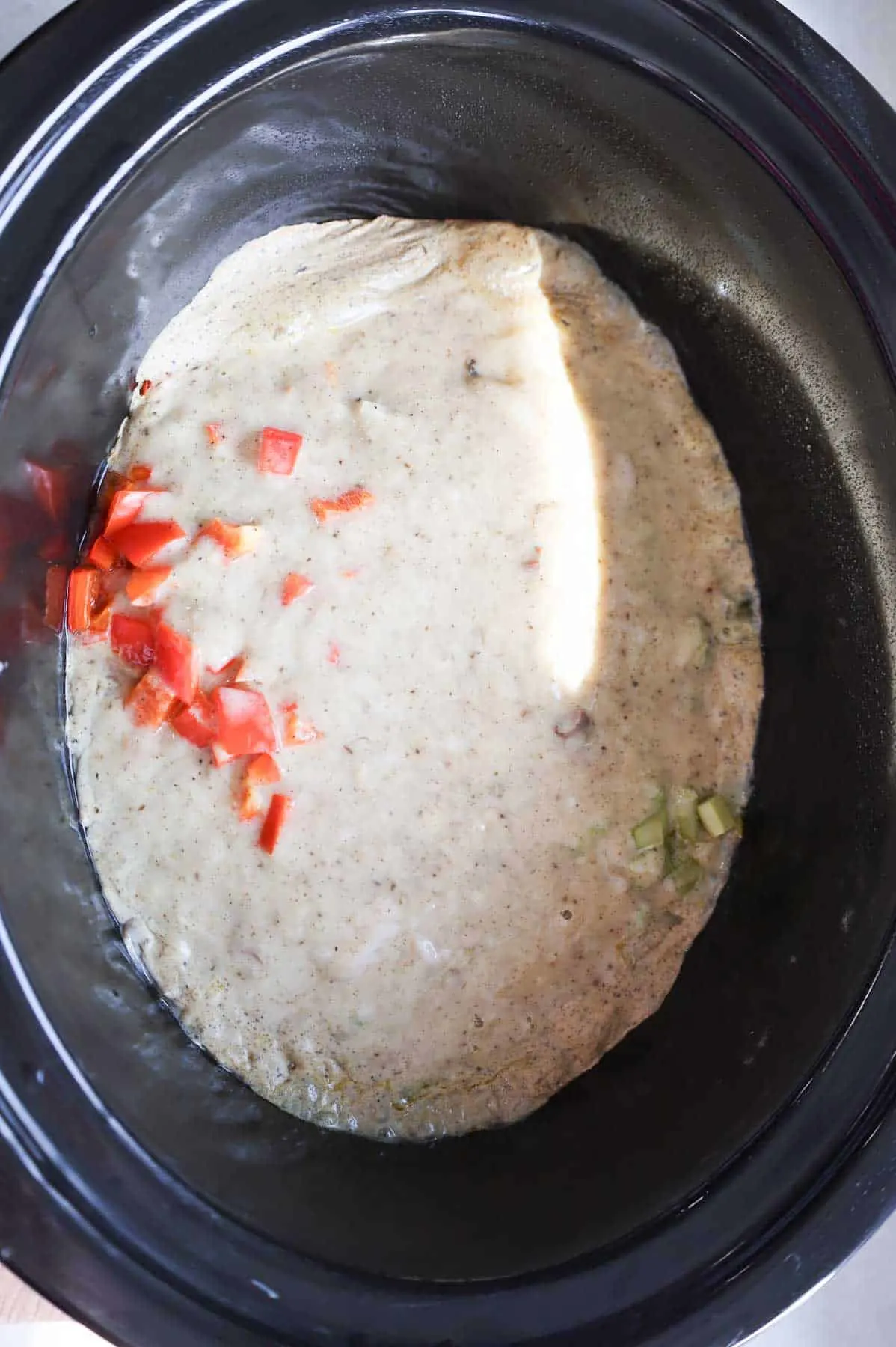 creamy chicken and veggie mixture cooking in a Crock Pot