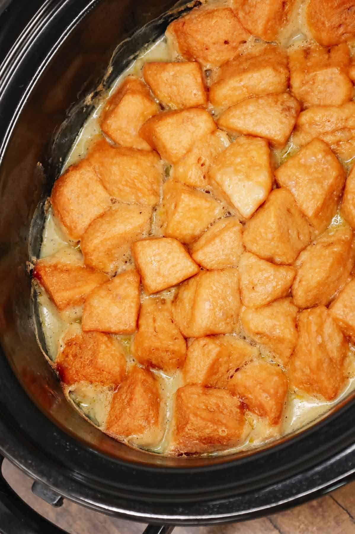 Crock Pot Chicken and Biscuits is a delicious comfort food dish made with boneless skinless chicken thighs, diced onions, celery, red and green bell peppers, cream of mushroom soup, cream of chicken soup, poultry seasoning and Pillsbury refrigerated biscuits.