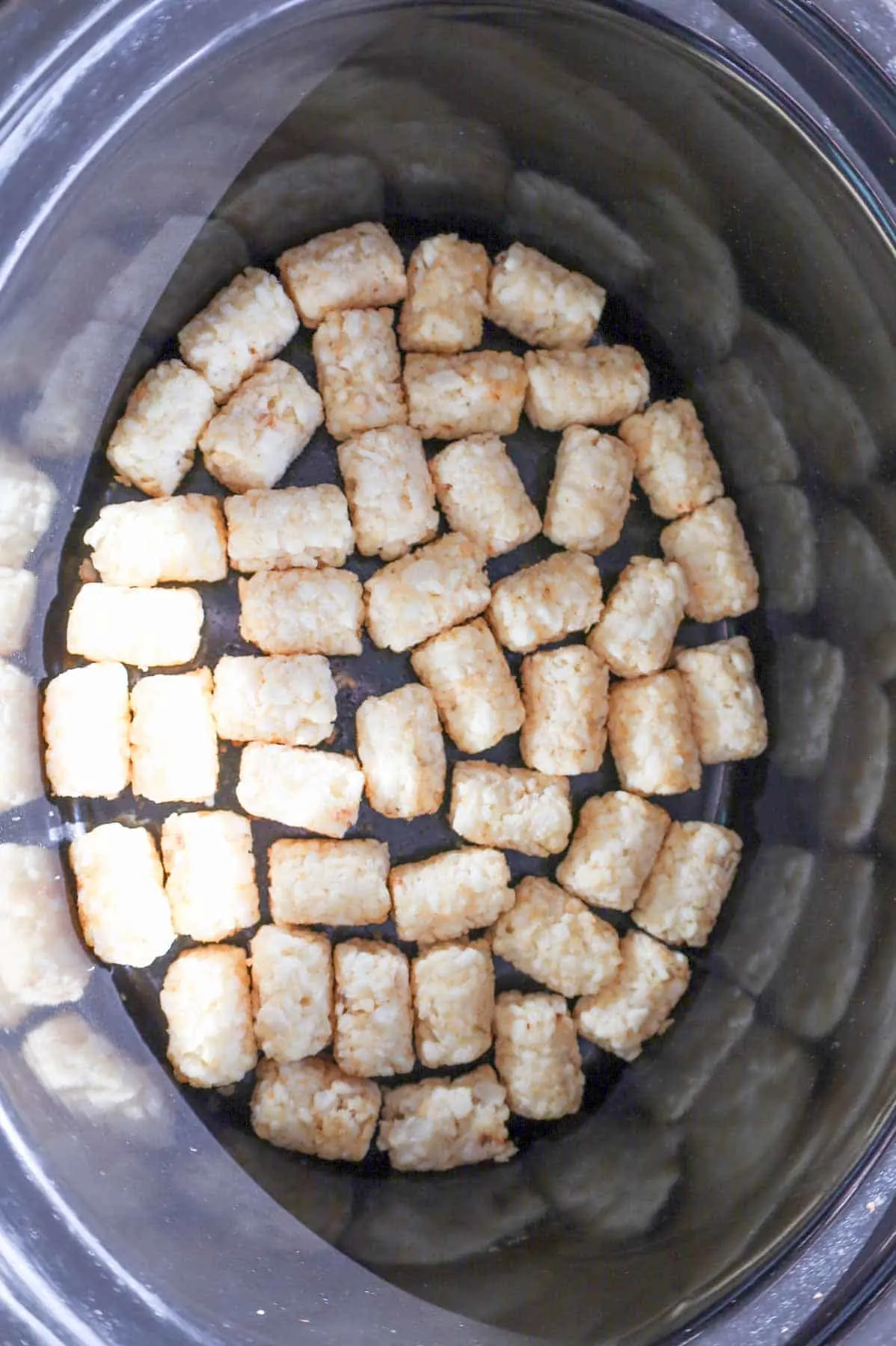 frozen tater tots in the bottom of crock pot