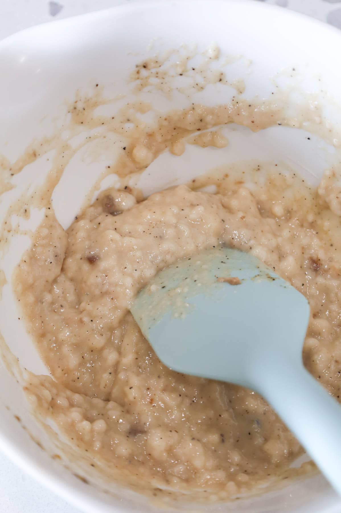 cream of mushroom soup and spices being stirred in a bowl