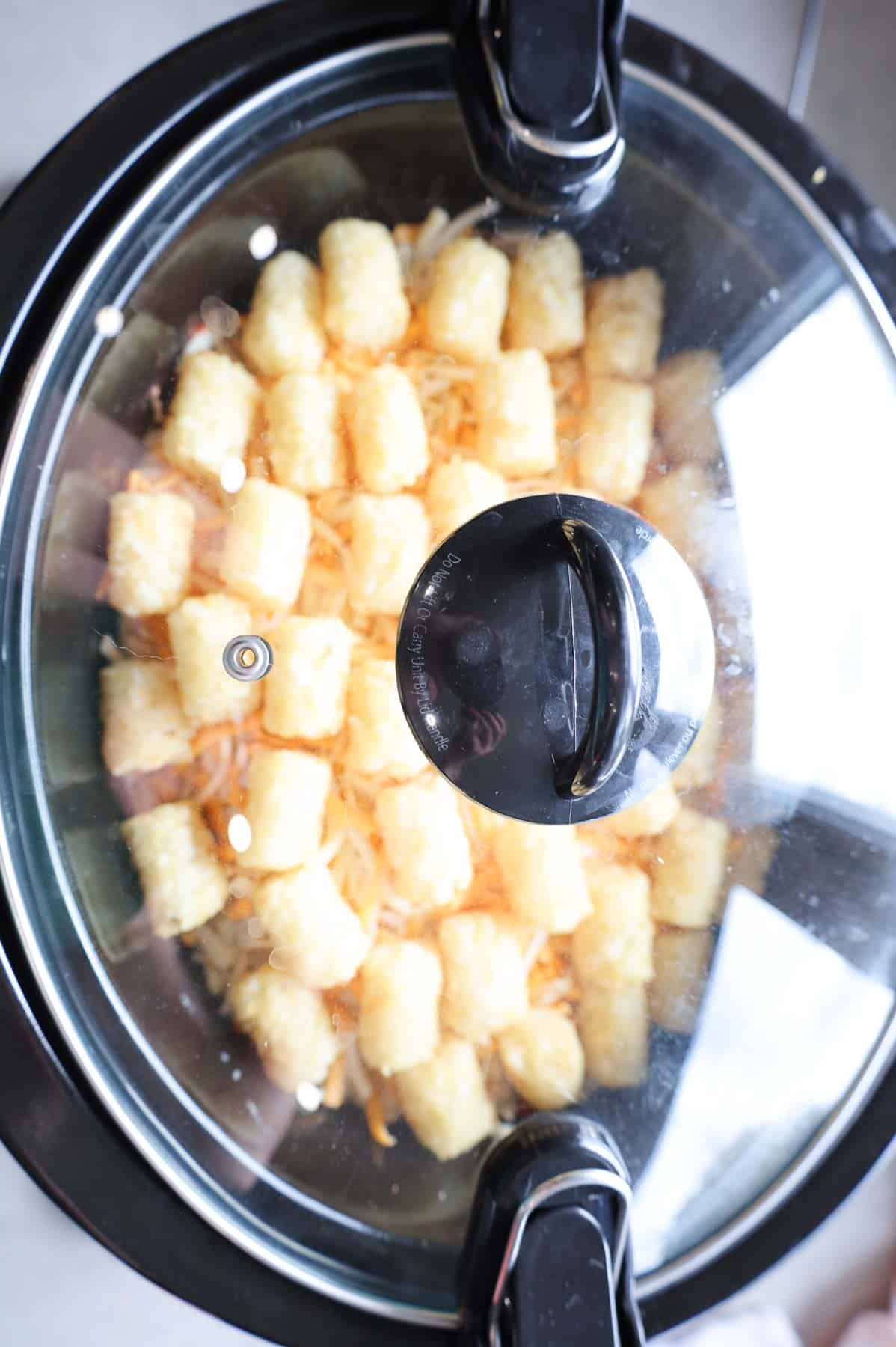 tater tot casserole in a slow cooker before cooking