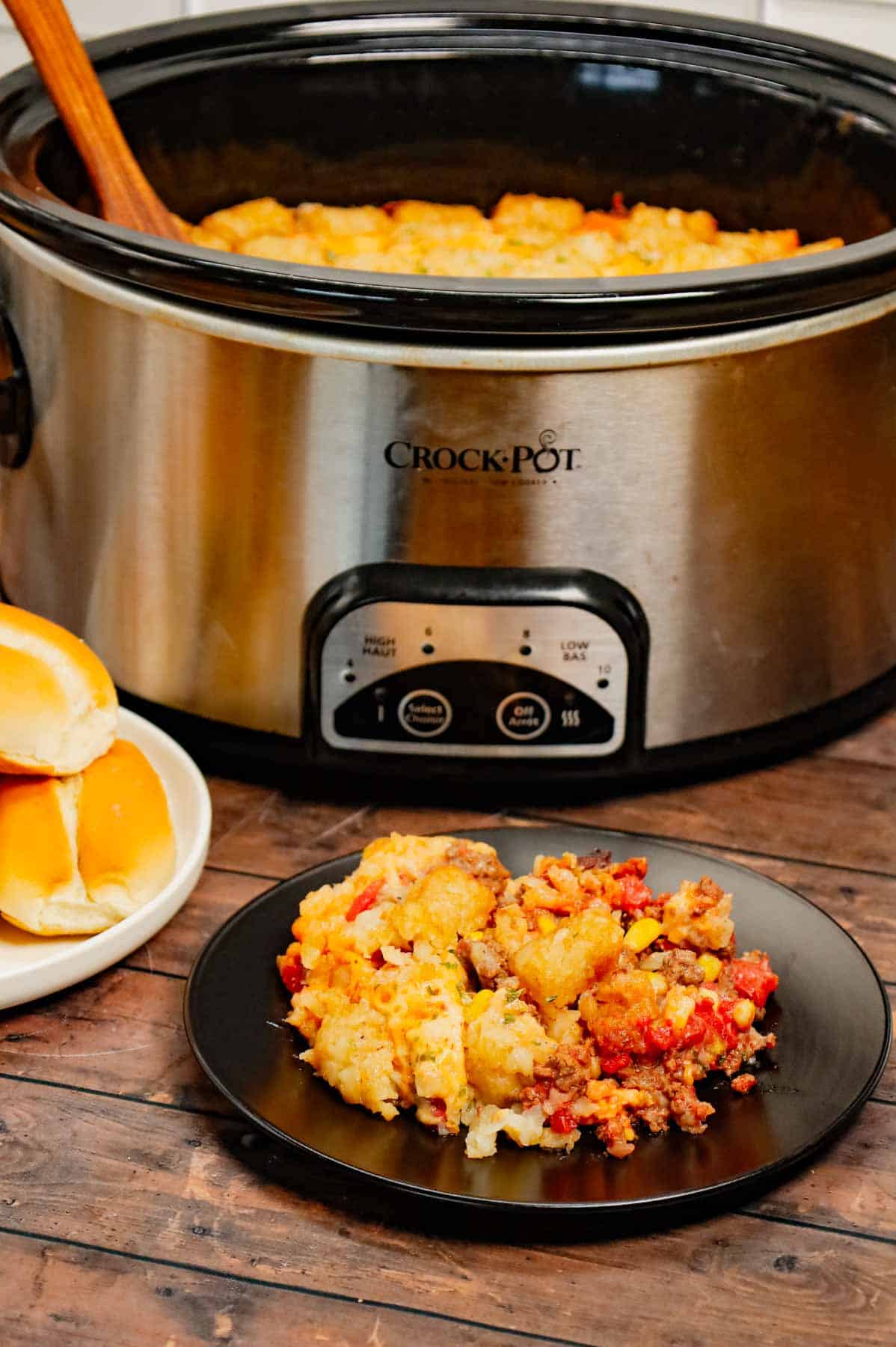 Crock Pot Tater Tot Casserole is a hearty slow cooker dish loaded with ground beef, tater tots, corn, diced tomatoes, cream of mushroom soup and shredded cheddar cheese.