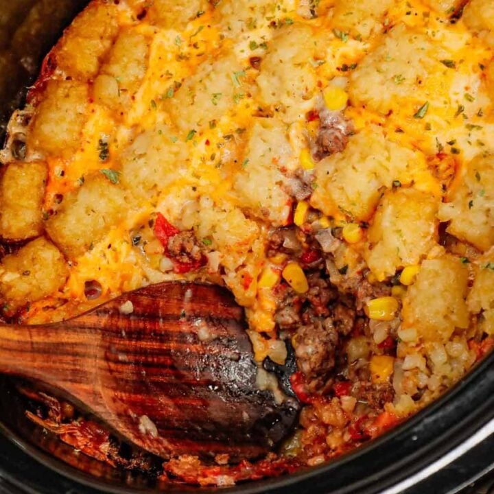 Crock Pot Tater Tot Casserole is a hearty slow cooker dish loaded with ground beef, tater tots, corn, diced tomatoes, cream of mushroom soup and shredded cheddar cheese.