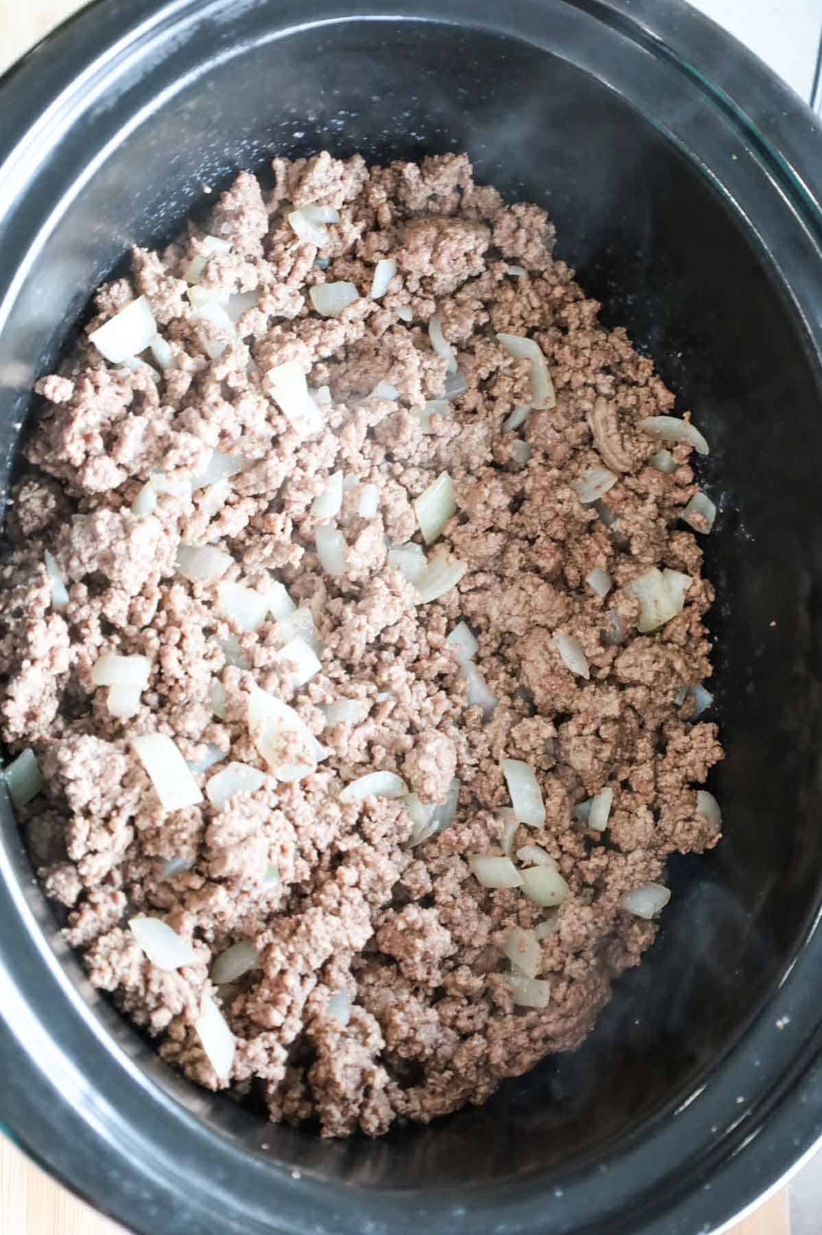 cooked ground beef and diced onions in a slow cooker