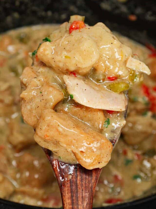 Crock Pot Chicken and Biscuits is a delicious comfort food dish made with boneless skinless chicken thighs, diced onions, celery, red and green bell peppers, cream of mushroom soup, cream of chicken soup, poultry seasoning and Pillsbury refrigerated biscuits.