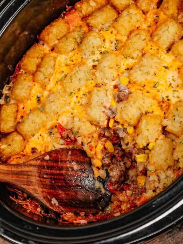 Crock Pot Tater Tot Casserole is a hearty slow cooker dish loaded with ground beef, tater tots, corn, diced tomatoes, cream of mushroom soup and shredded cheddar cheese.
