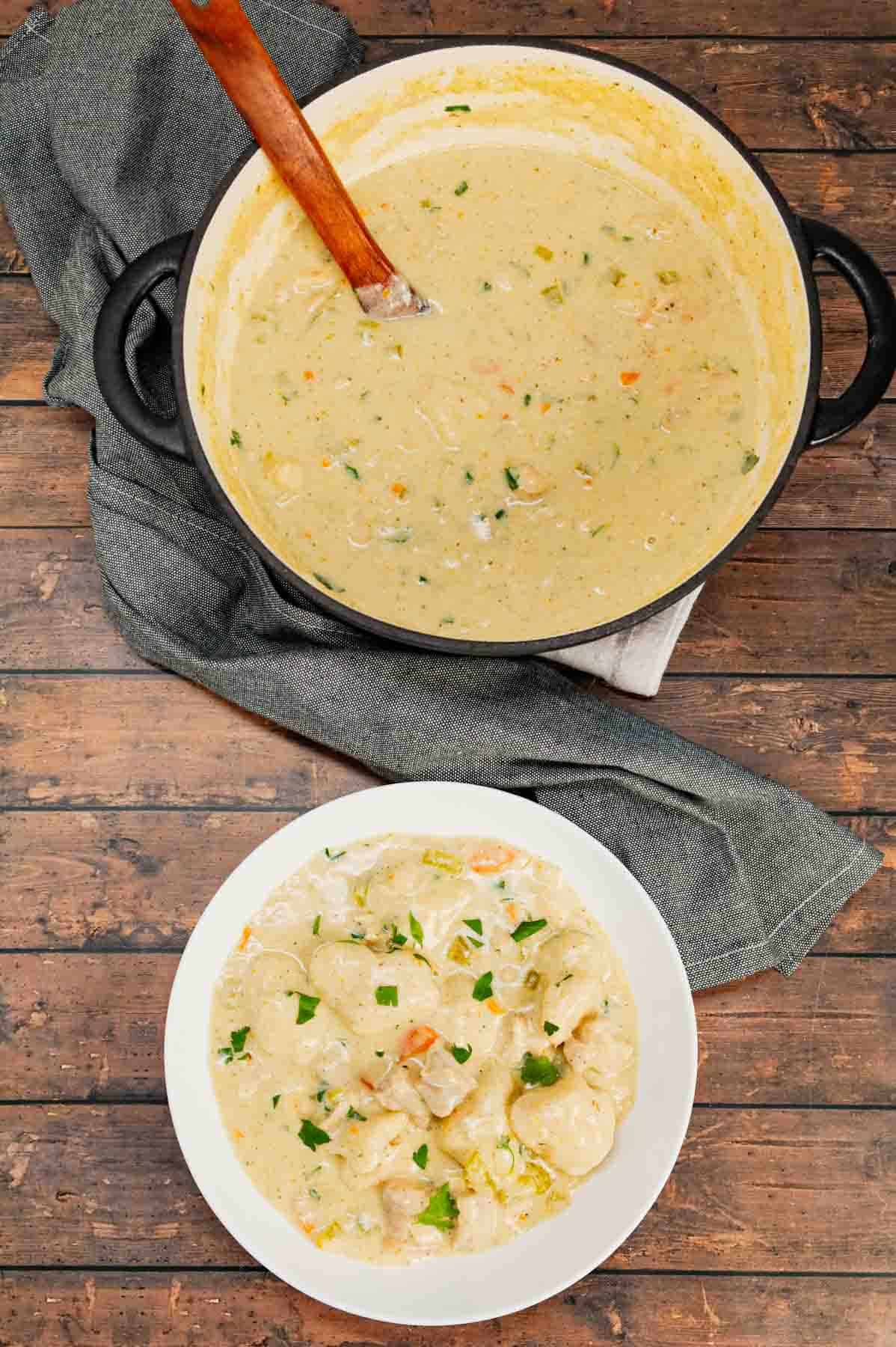 Dutch Oven Chicken and Dumplings is hearty dinner recipe loaded with chunks of chicken, onion, celery, carrots and soft doughy Bisquick dumplings all in a creamy and flavourful broth.