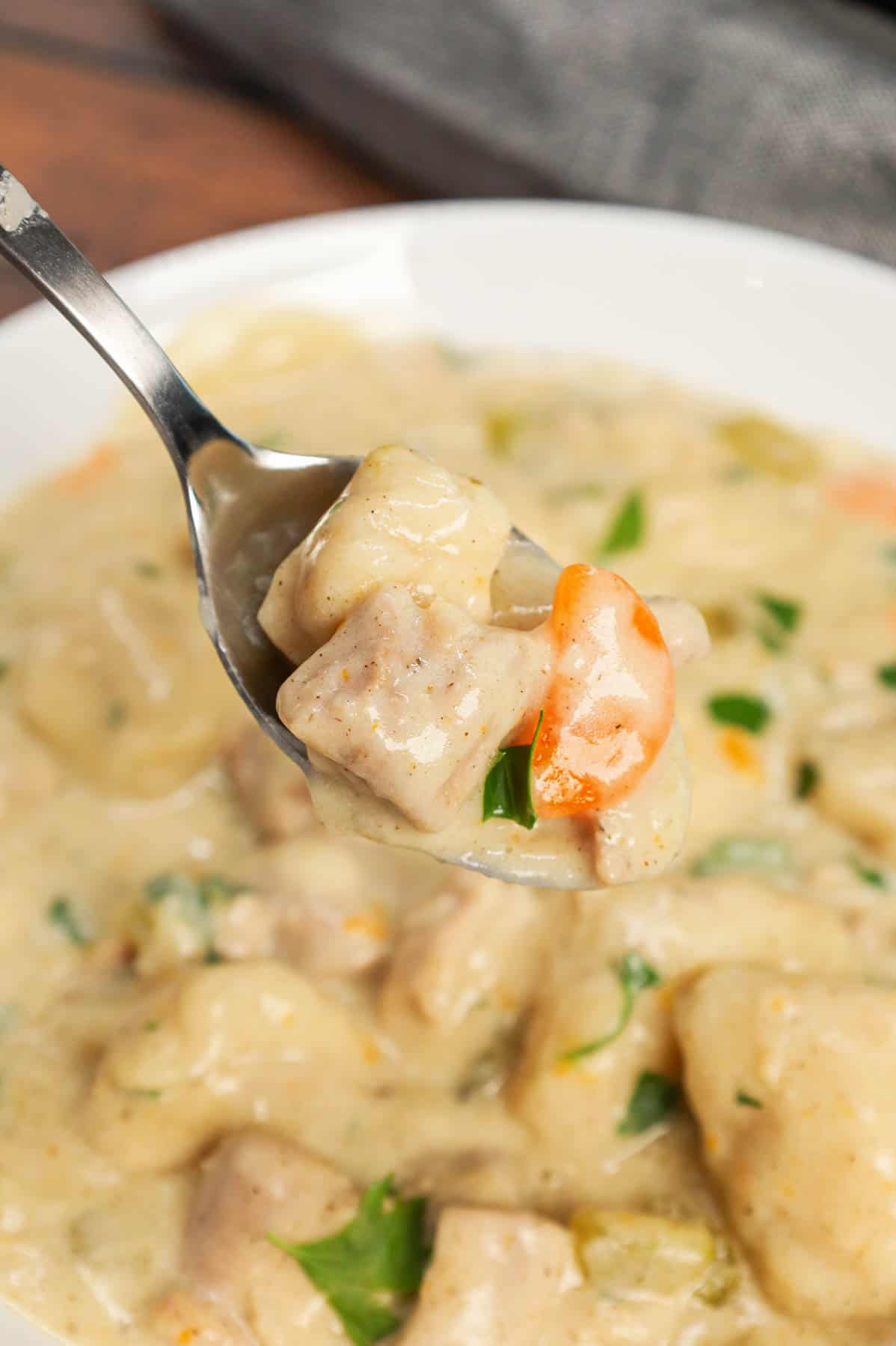 Dutch Oven Chicken and Dumplings is hearty dinner recipe loaded with chunks of chicken, onion, celery, carrots and soft doughy Bisquick dumplings all in a creamy and flavourful broth.