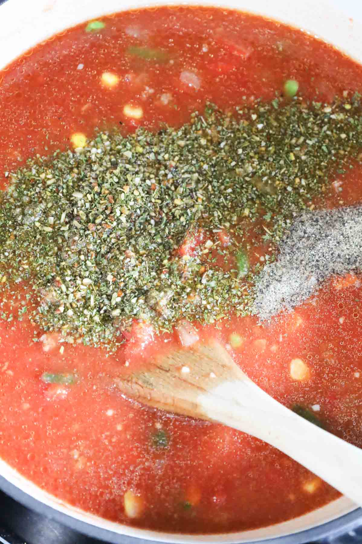Italian seasoning added to pot with hamburger soup