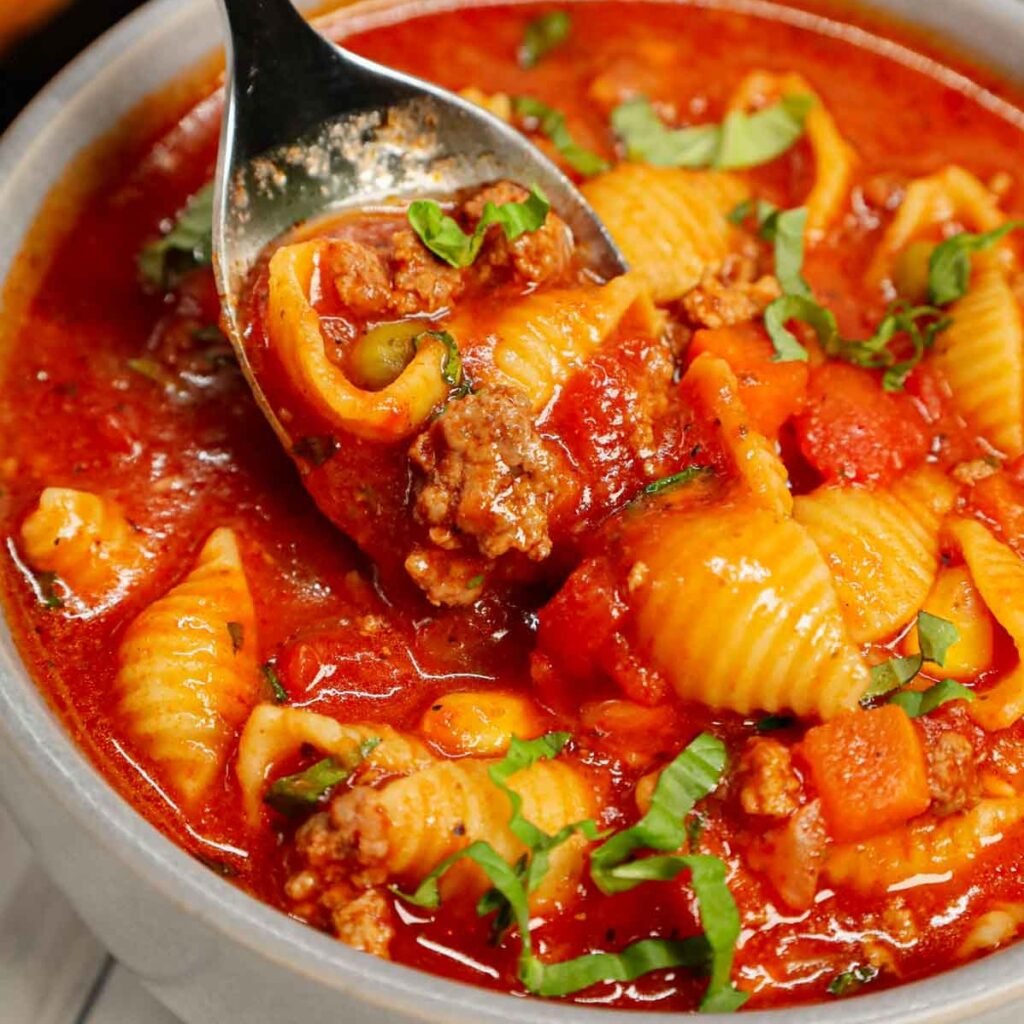 Italian Hamburger Soup is a hearty ground beef soup recipe loaded with mixed frozen veggies, diced tomatoes, Italian seasoning and small pasta shells all in a delicious tomato beef broth.