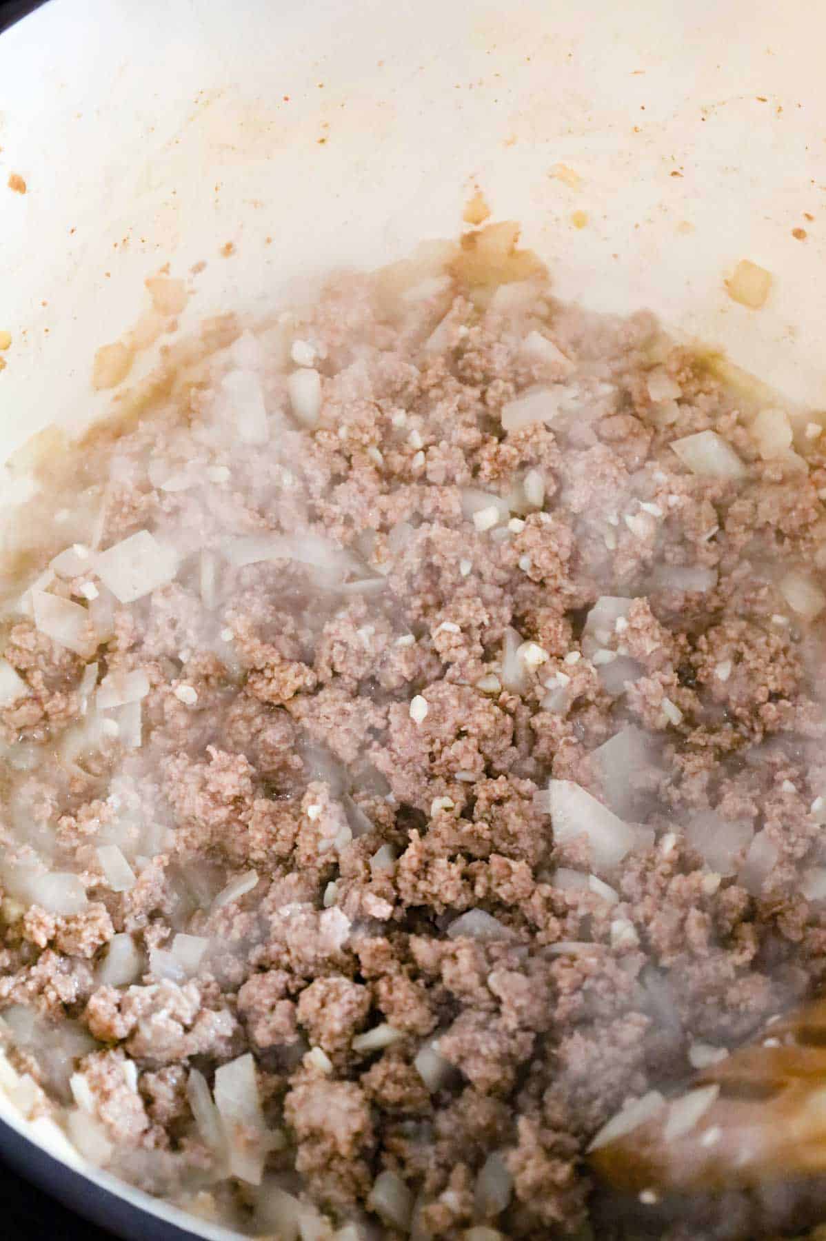 cooked ground beef, diced onions and minced garlic in a pot