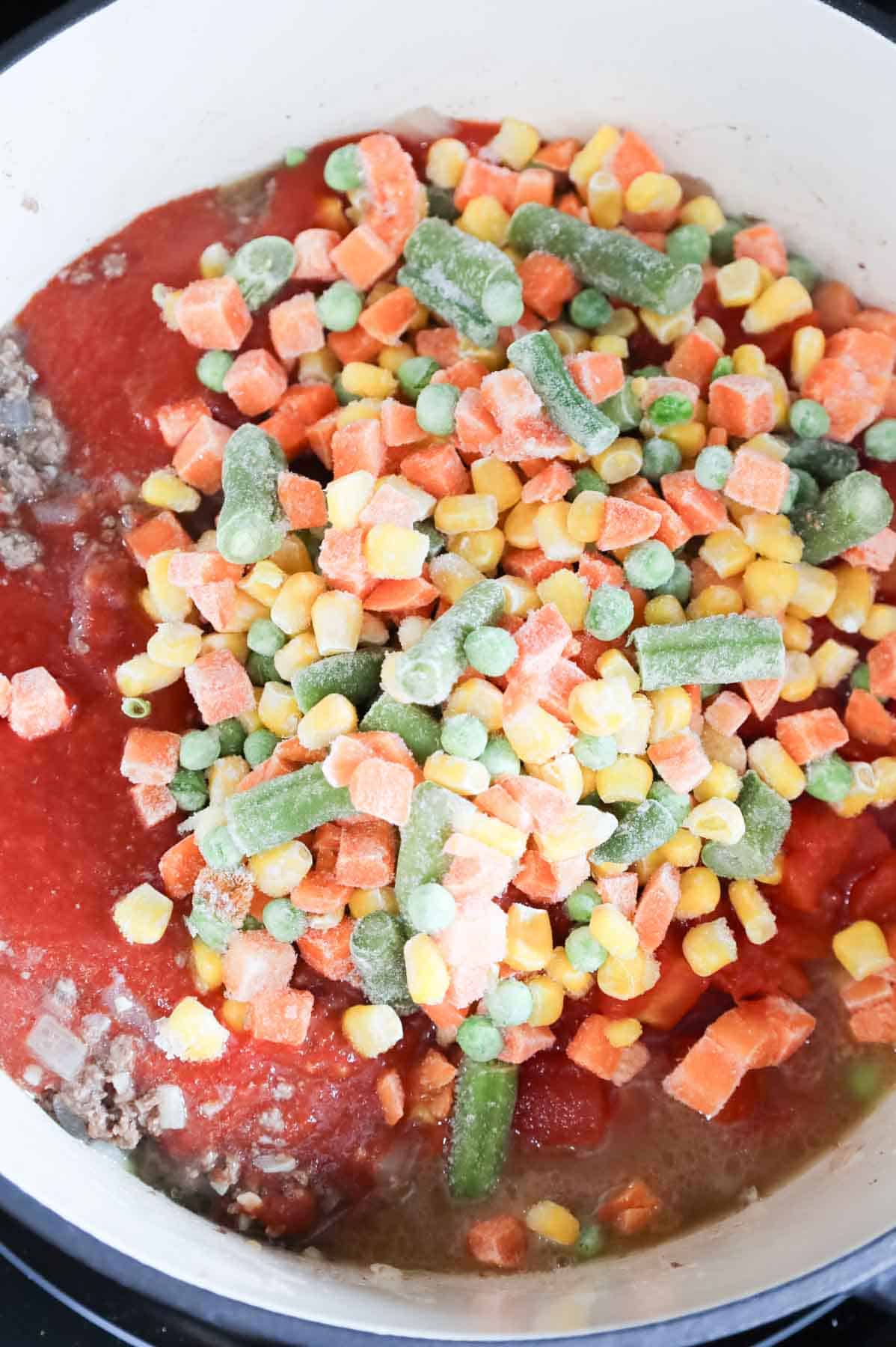frozen mixed veggies added to pot with diced tomatoes, tomato sauce and cooked ground beef