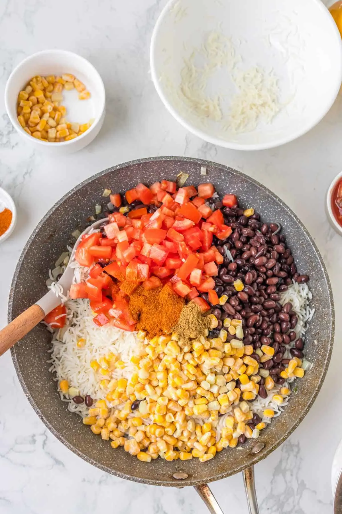 diced tomatoes, black beans, and corn added to skillet with cooked rice