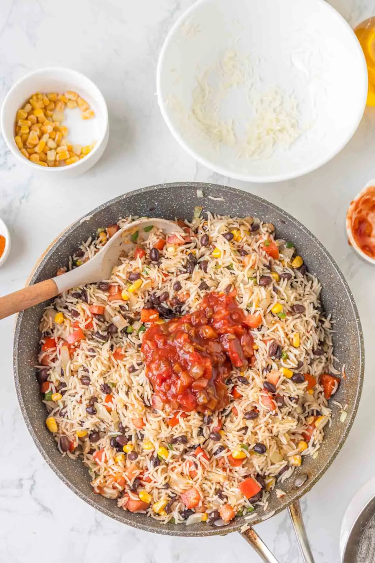 salsa added to skillet with fried rice mixture
