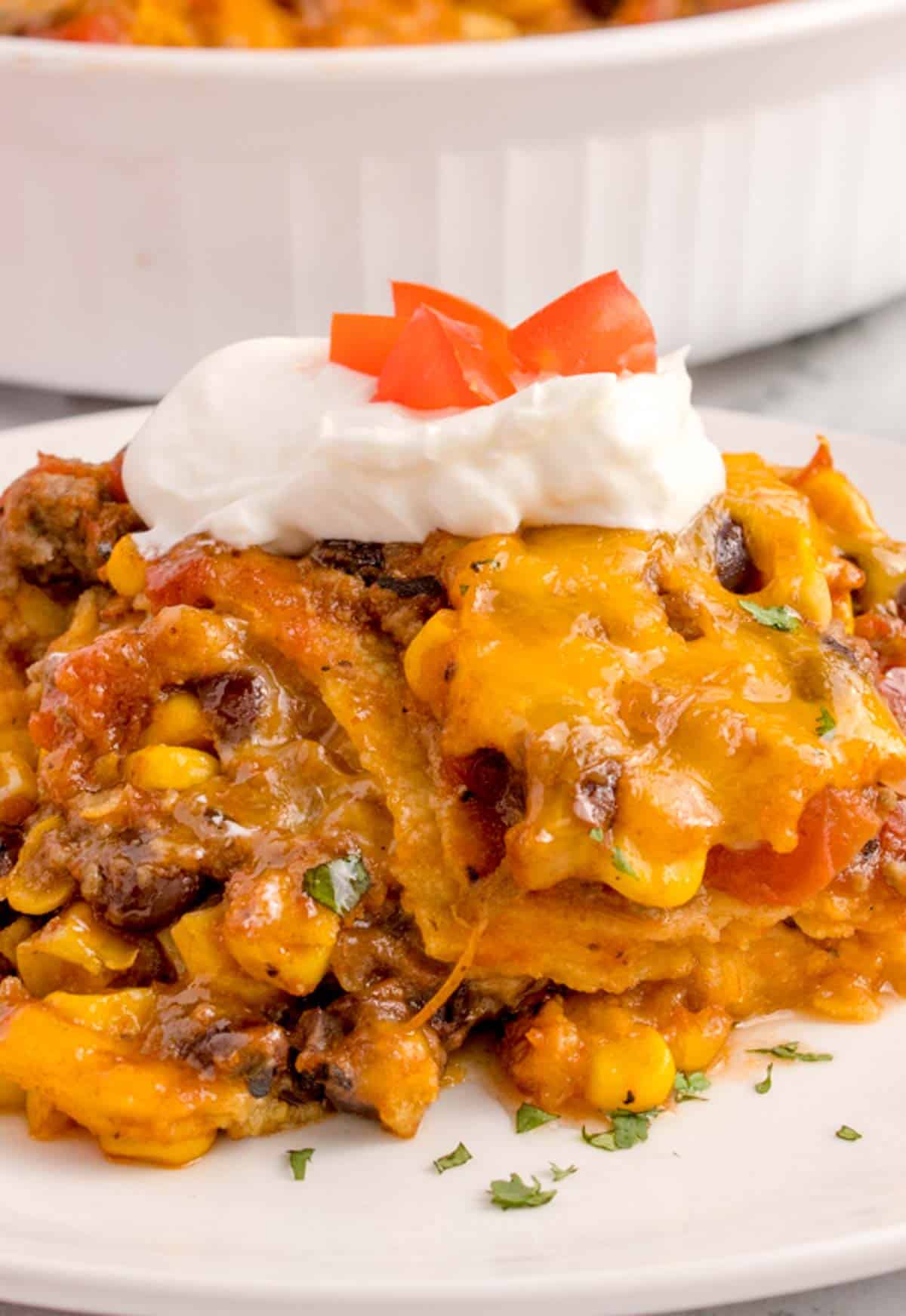 Mexican Ground Beef Casserole is a hearty dish loaded with ground beef, diced tomatoes, black beans, corn, cheddar cheese and corn tortillas.