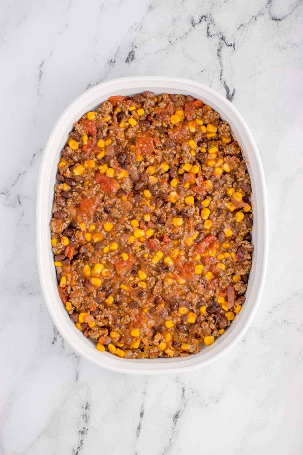 ground beef mixture spread in a baking dish