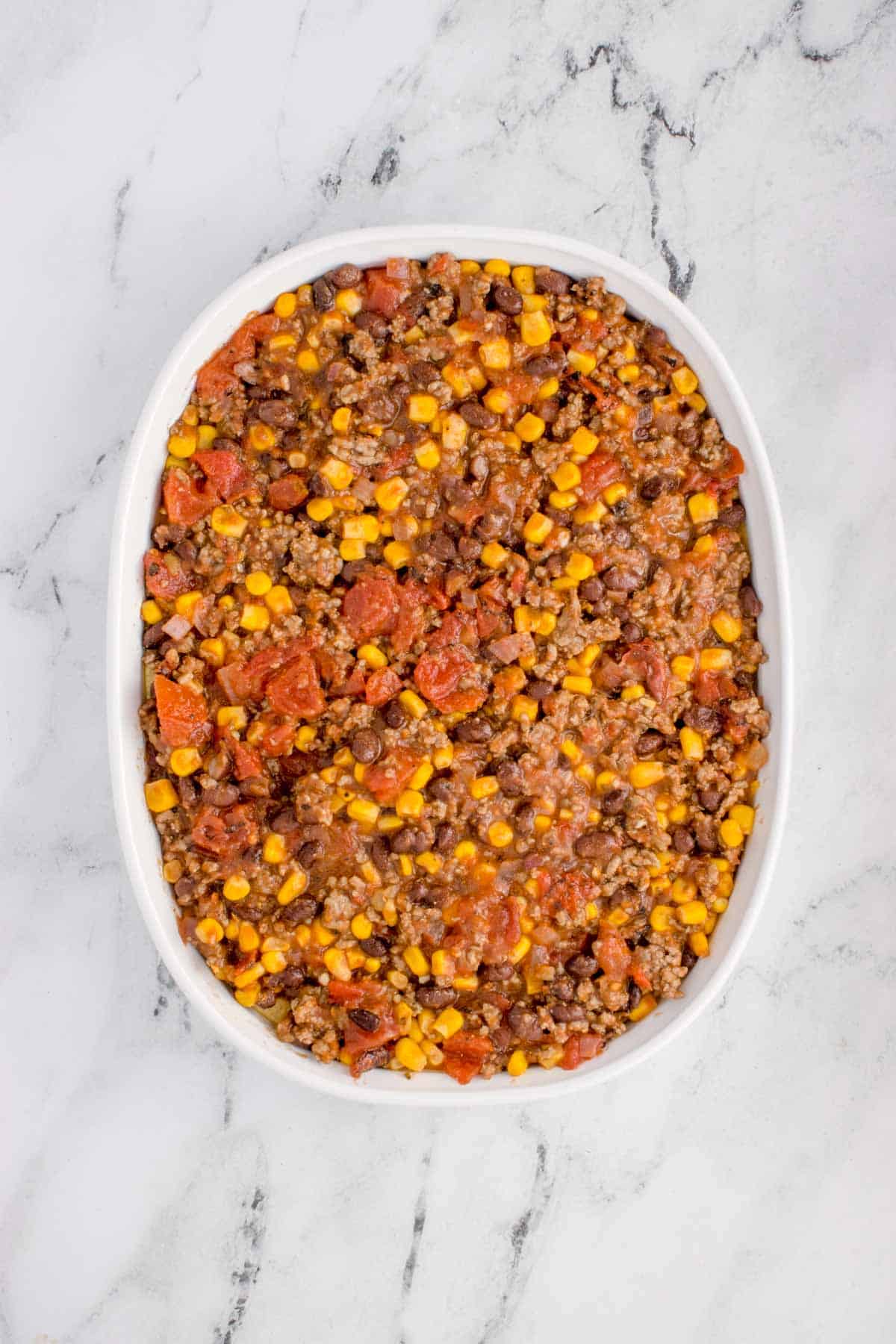 ground beef, corn and tomato mixture in a baking dish
