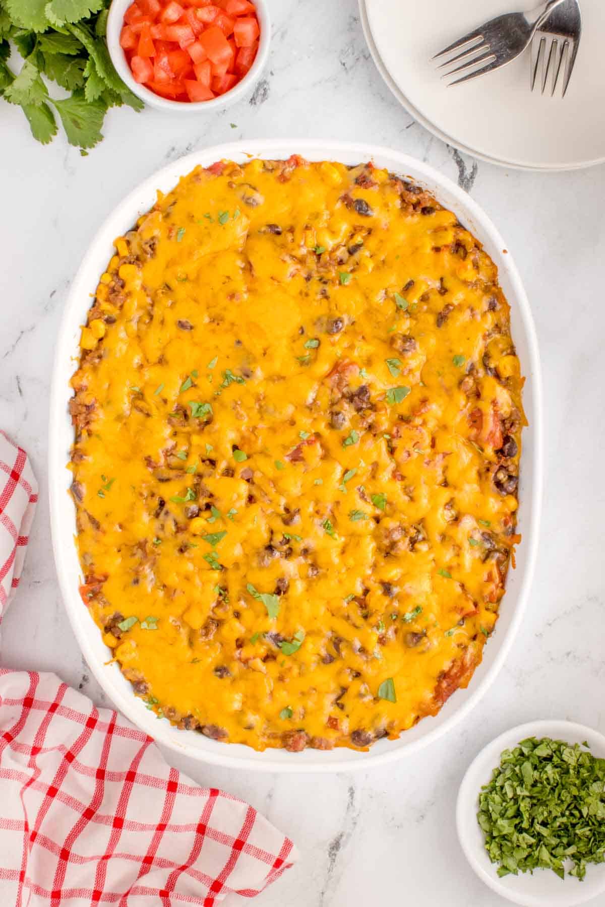 Mexican Ground Beef Casserole is a hearty dish loaded with ground beef, diced tomatoes, black beans, corn, cheddar cheese and corn tortillas.