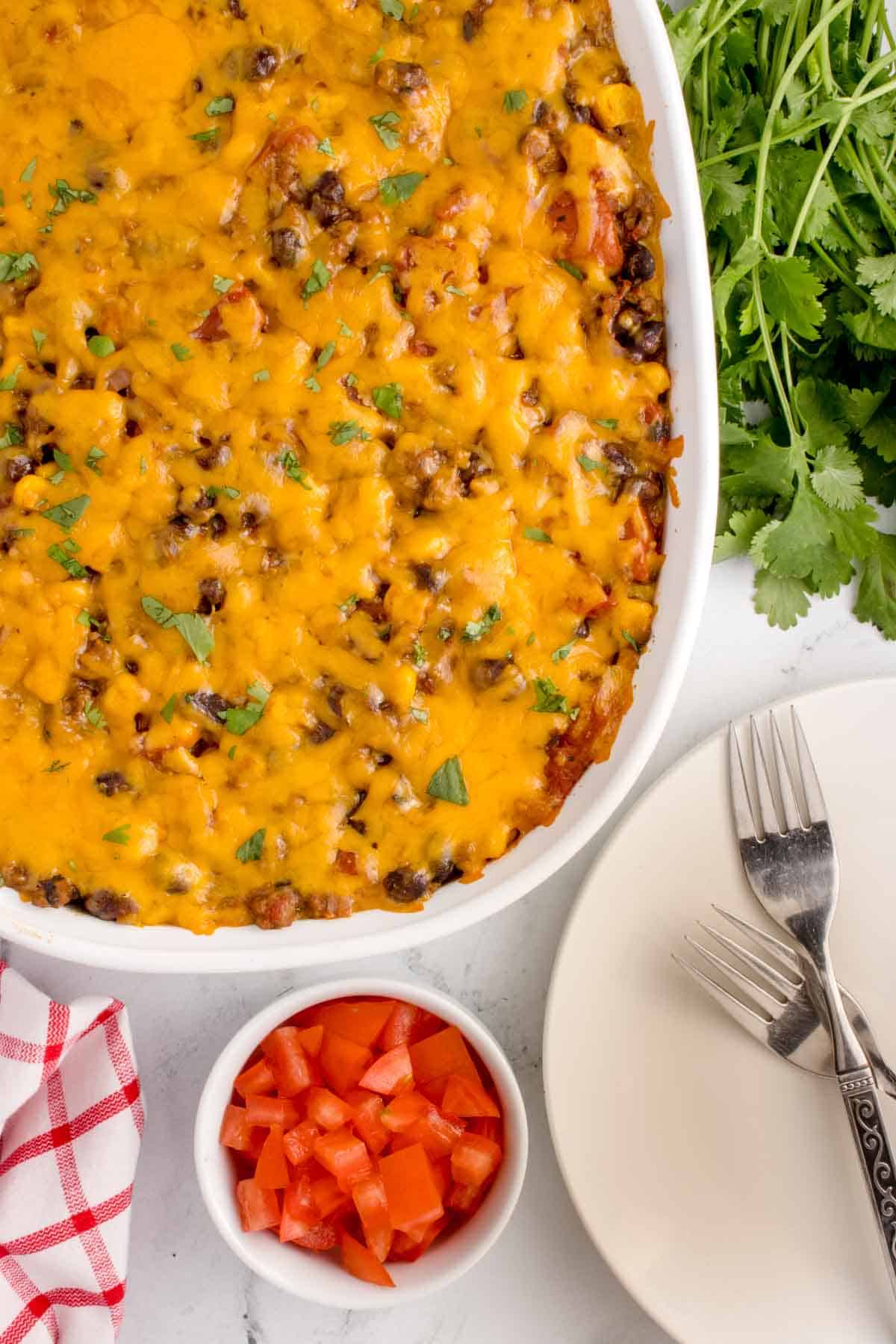 Mexican Ground Beef Casserole is a hearty dish loaded with ground beef, diced tomatoes, black beans, corn, cheddar cheese and corn tortillas.