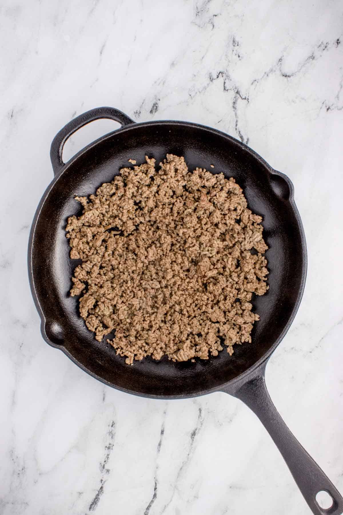 cooked and crumbled ground beef in a skillet