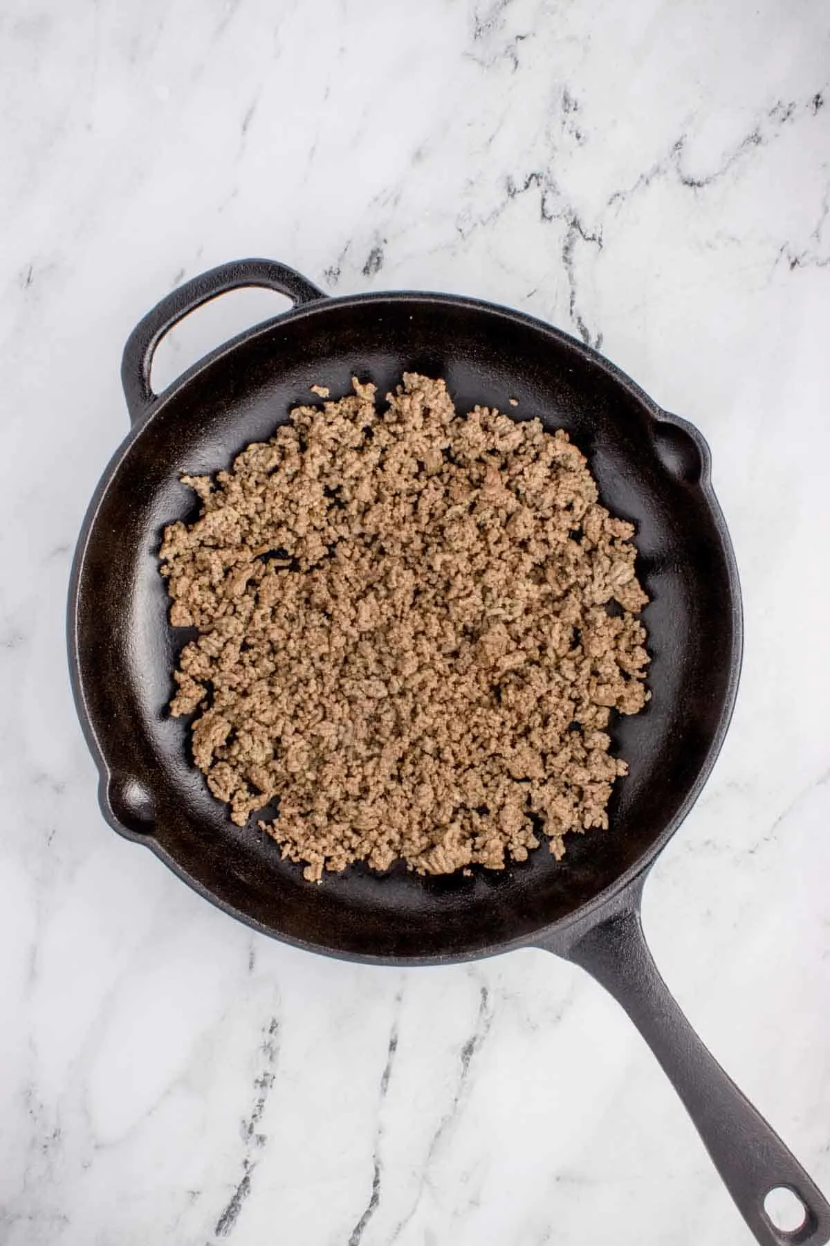 cooked and crumbled ground beef in a skillet