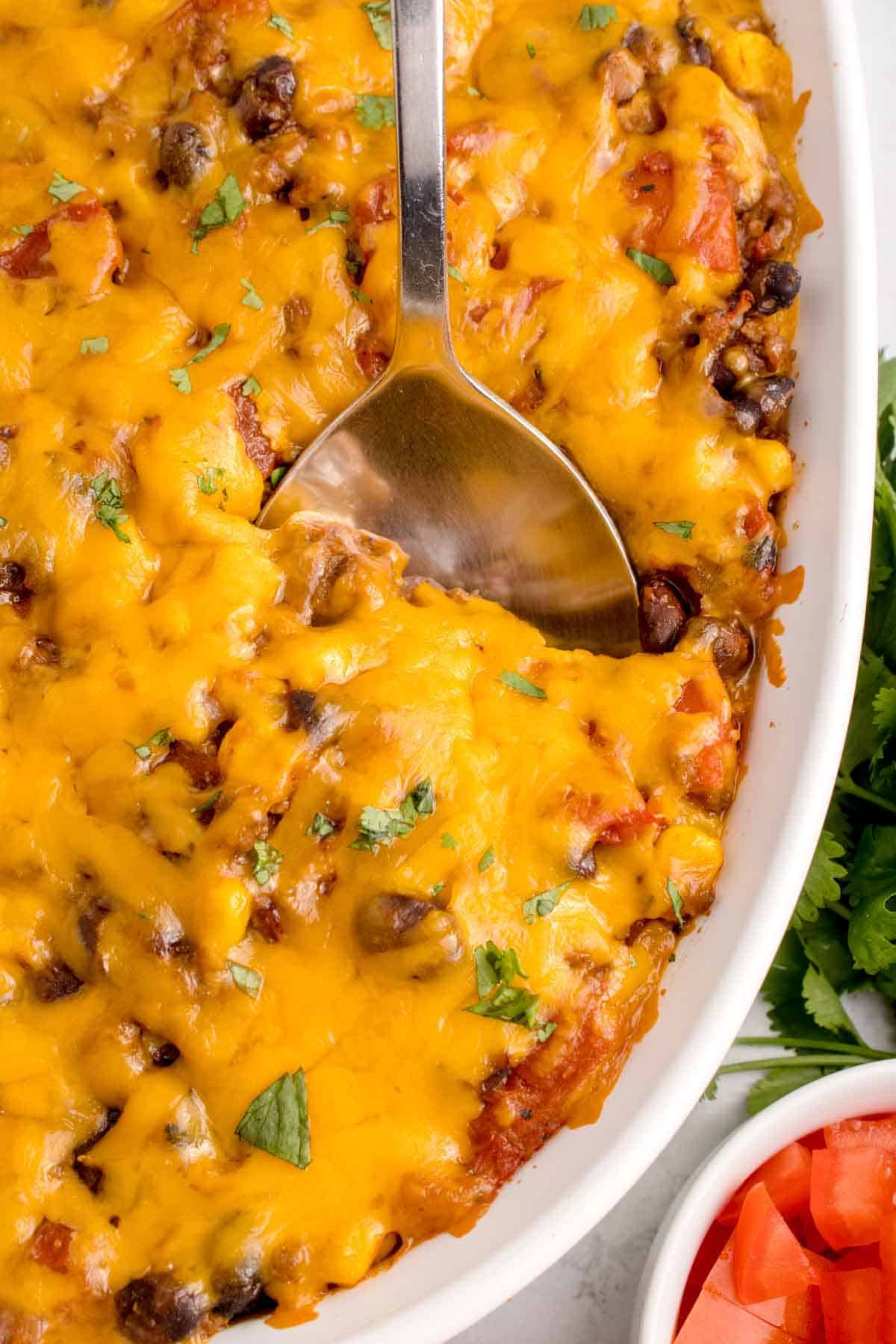 Mexican Ground Beef Casserole is a hearty dish loaded with ground beef, diced tomatoes, black beans, corn, cheddar cheese and corn tortillas.