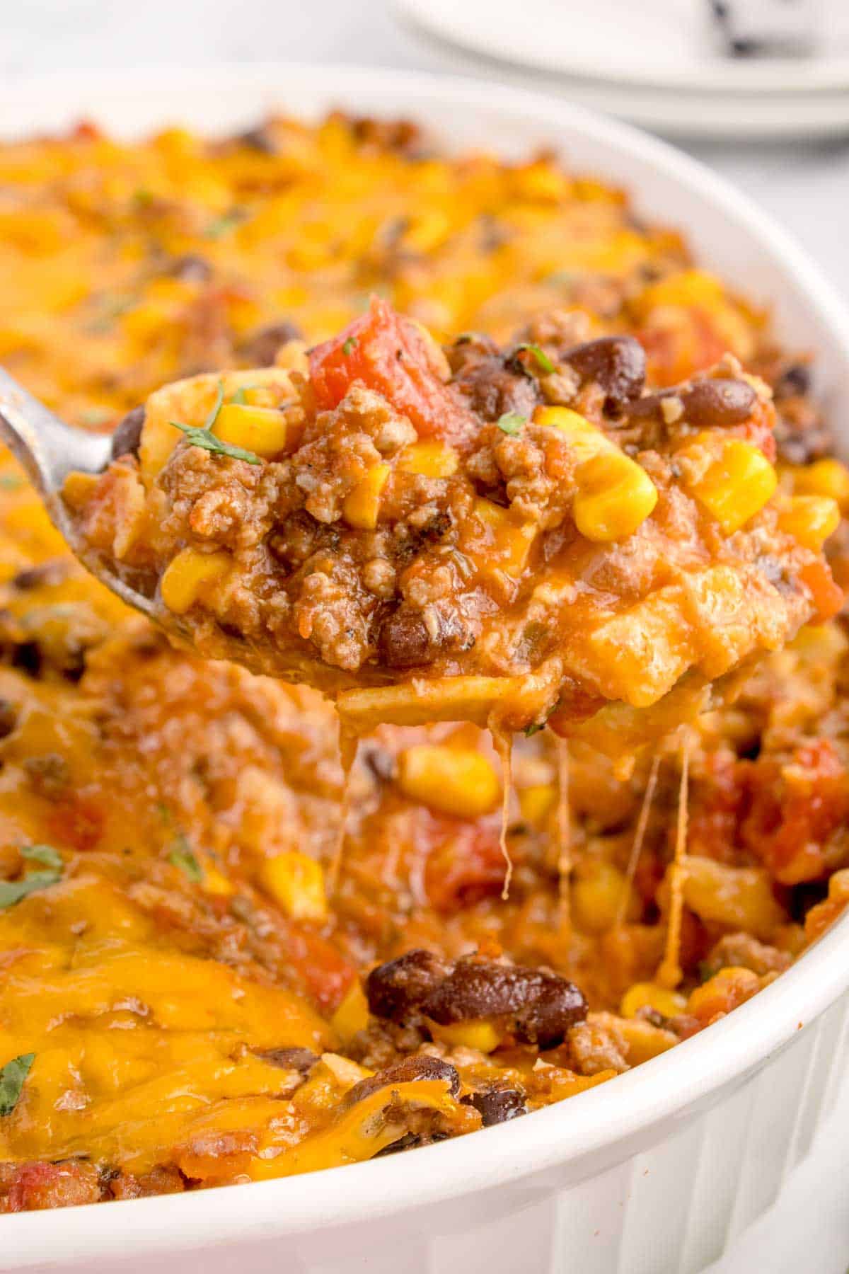Mexican Ground Beef Casserole is a hearty dish loaded with ground beef, diced tomatoes, black beans, corn, cheddar cheese and corn tortillas.