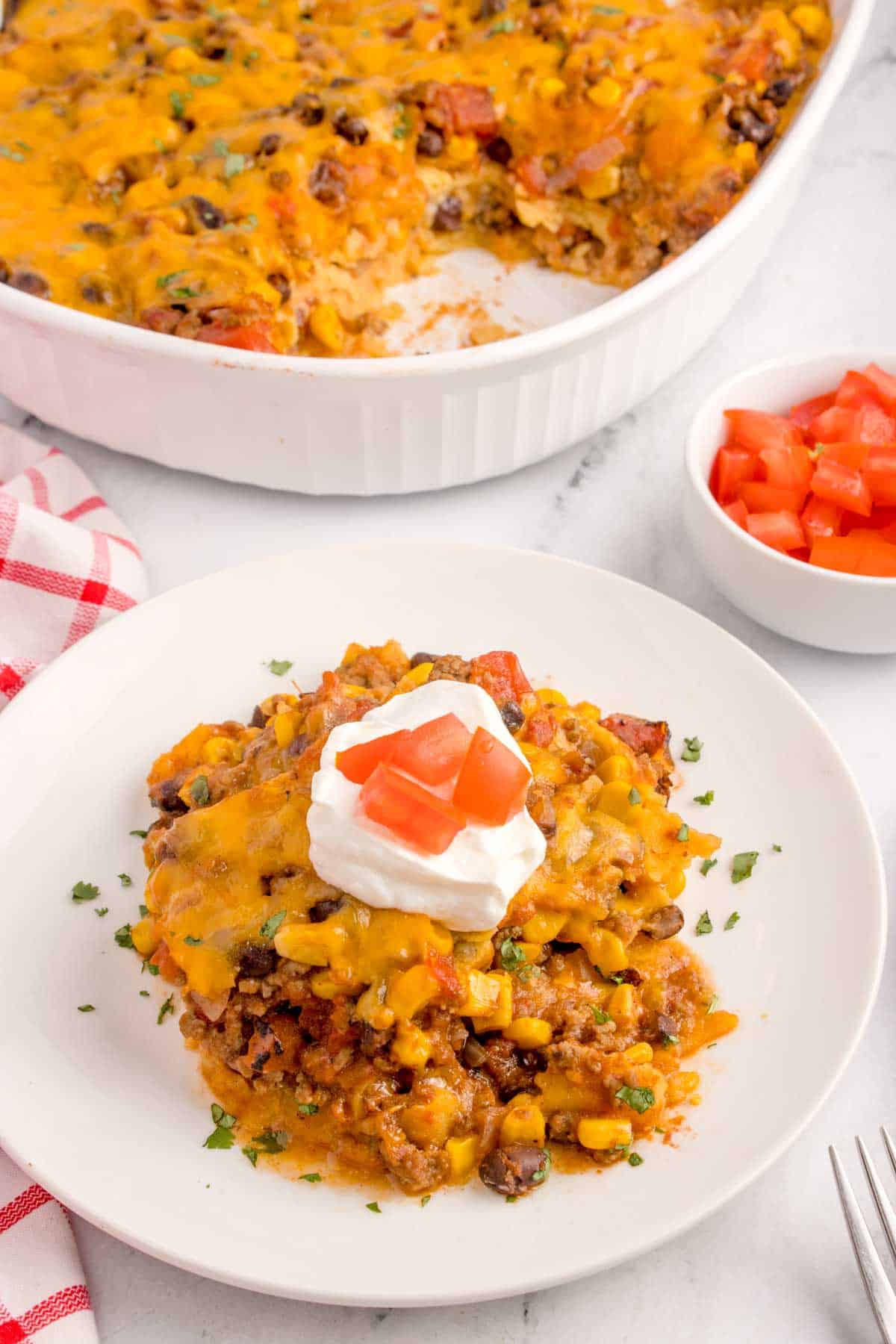 Mexican Ground Beef Casserole is a hearty dish loaded with ground beef, diced tomatoes, black beans, corn, cheddar cheese and corn tortillas.