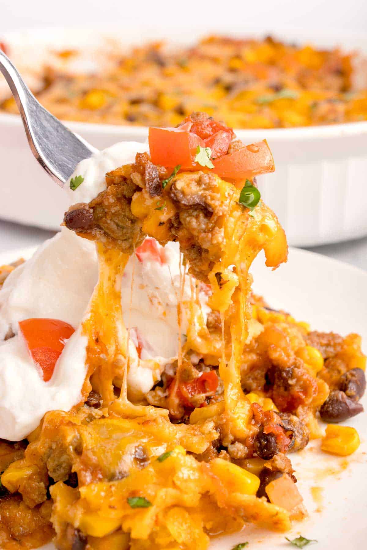 Mexican Ground Beef Casserole is a hearty dish loaded with ground beef, diced tomatoes, black beans, corn, cheddar cheese and corn tortillas.