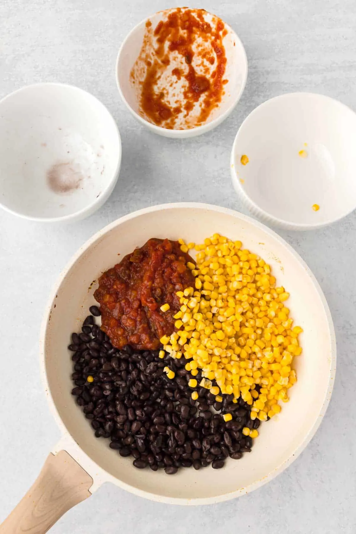 salsa, corn and black beans in a skillet