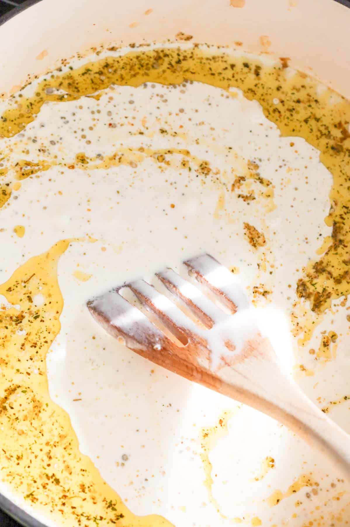 heavy cream added to skillet with butter and Italian seasoning