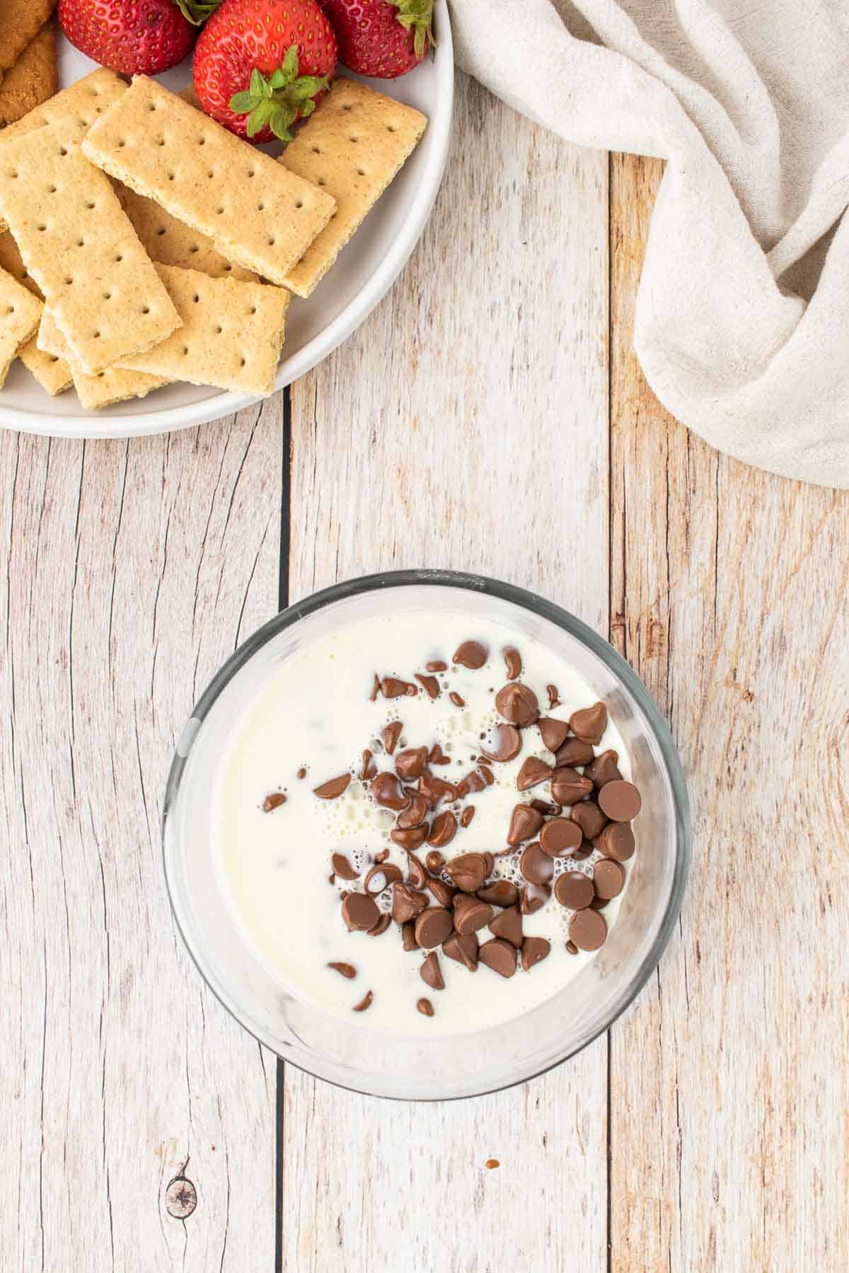 heavy cream poured over chocolate chips in a bowl