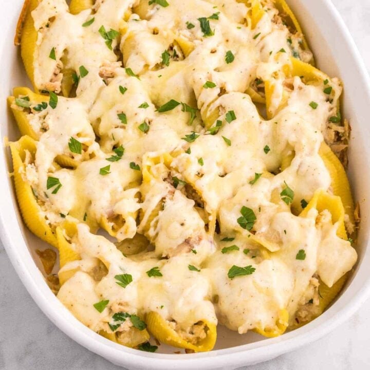 Tuna Stuffed Shells are delicious jumbo pasta shells stuffed with tuna, ricotta, parmesan and mozzarella and smothered in a creamy garlic sauce.